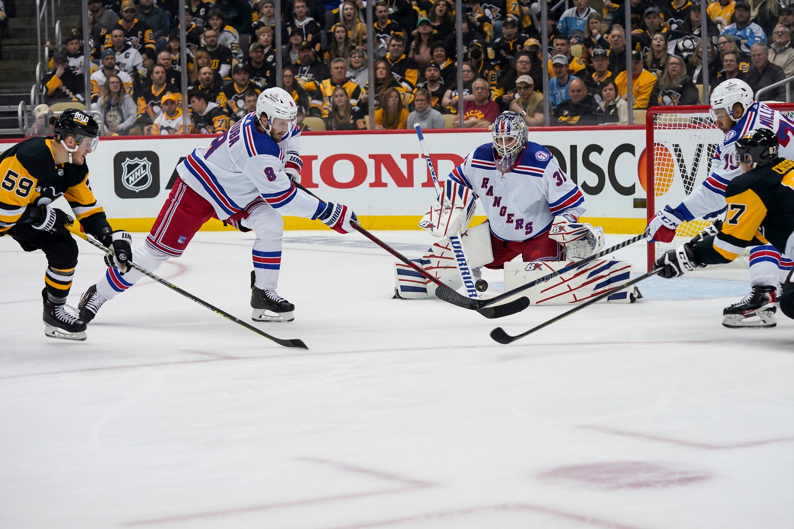 PITTSBURGH, PA - MAY 07: New York Rangers goaltender Igor Shesterkin (31) follows the puck with Pittsburgh Penguins left wing Jake Guentzel (59) and Pittsburgh Penguins center Sidney Crosby (87) in front as New York Rangers defenseman Jacob Trouba (8) defends during the first period in Game Three of the First Round in the 2022 NHL Stanley Cup Playoffs between the New York Rangers and the Pittsburgh Penguins on May 7, 2022, at PPG Paints Arena in Pittsburgh, PA. (Photo by Jeanine Leech/Icon Sportswire via Getty Images)