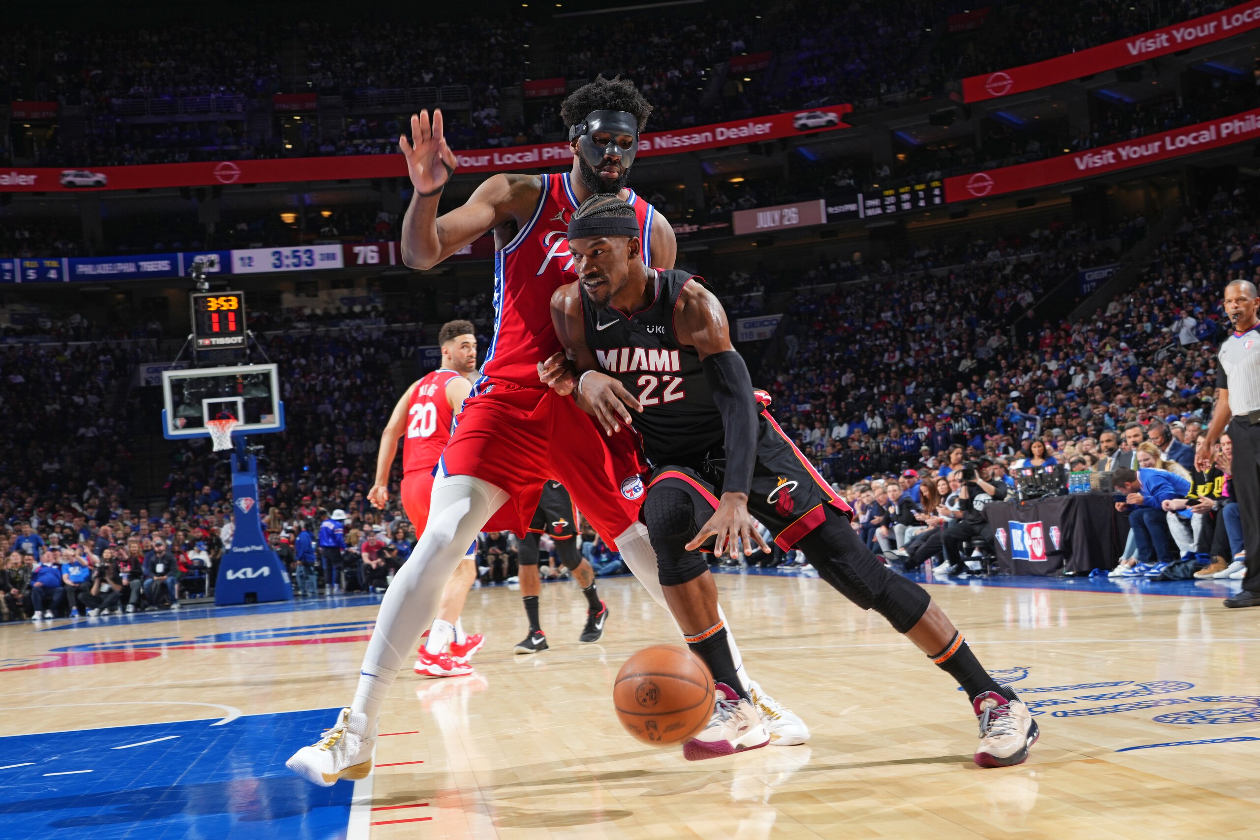 PHILADELPHIA, PA - MAY 8: Jimmy Butler #22 of the Miami Heat handles the ball against Joel Embiid #21 of the Philadelphia 76ers during Game 4 of the 2022 NBA Playoffs Eastern Conference Semifinals on May 8, 2022 at Wells Fargo Center in Philadelphia, Pennsylvania. NOTE TO USER: User expressly acknowledges and agrees that, by downloading and/or using this Photograph, user is consenting to the terms and conditions of the Getty Images License Agreement. Mandatory Copyright Notice: Copyright 2022 NBAE (Photo by Jesse D. Garrabrant/NBAE via Getty Images)
