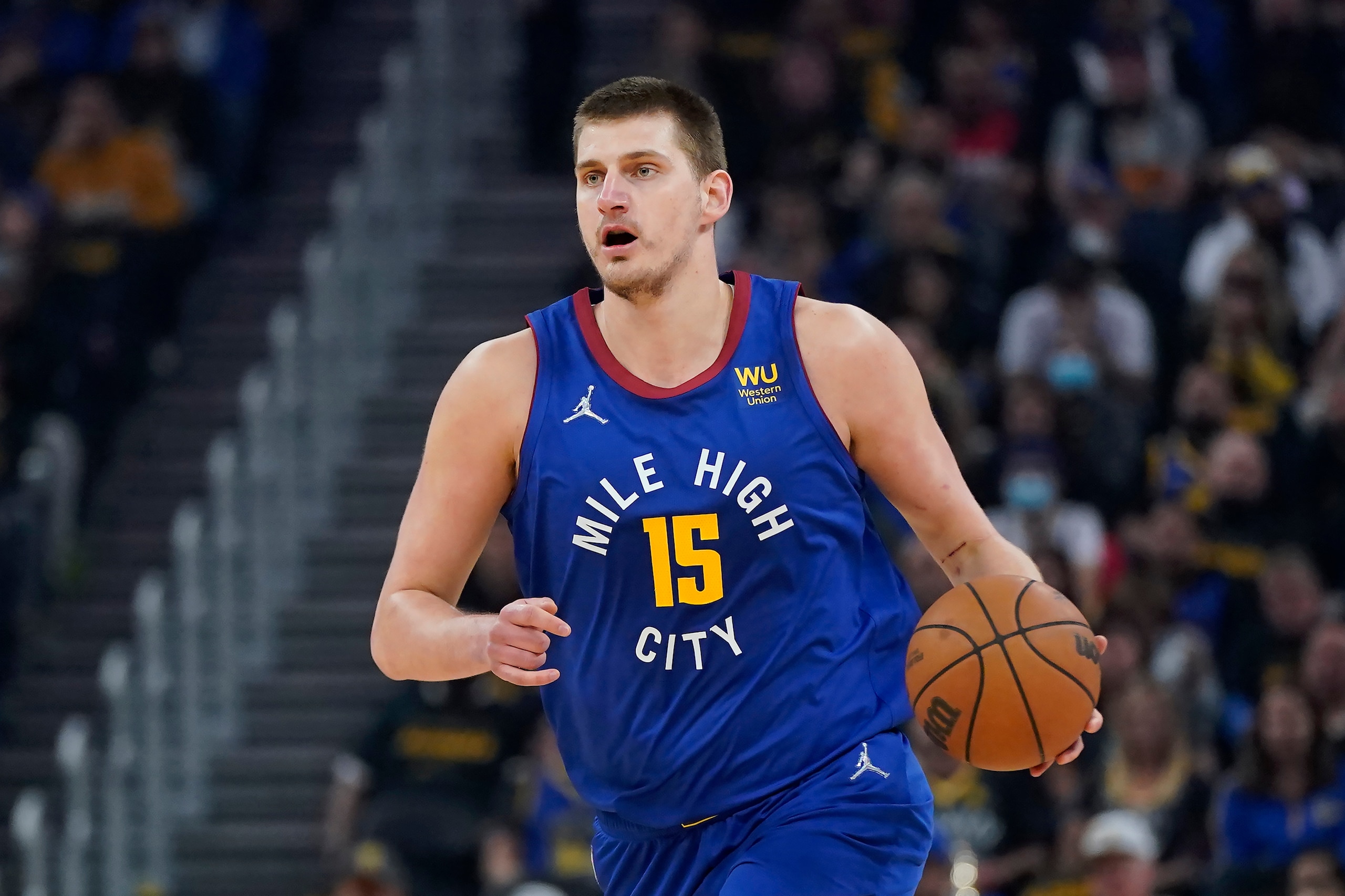 FILE - Denver Nuggets center Nikola Jokic (15) dribbles the ball up the court against the Golden State Warriors during the first half of Game 2 of an NBA basketball first-round playoff series in San Francisco, Monday, April 18, 2022. Jokic has won his second consecutive Most Valuable Player award after a season in which he finished with numbers never before seen in NBA history, a person familiar with the decision told The Associated Press on Monday, May 9, 2022. (AP Photo/Jeff Chiu, File) FILE - Denver Nuggets center Nikola Jokic (15) dribbles the ball up the court against the Golden State Warriors during the first half of Game 2 of an NBA basketball first-round playoff series in San Francisco, Monday, April 18, 2022. Jokic has won his second consecutive Most Valuable Player award after a season in which he finished with numbers never before seen in NBA history, a person familiar with the decision told The Associated Press on Monday, May 9, 2022. (AP Photo/Jeff Chiu, File)