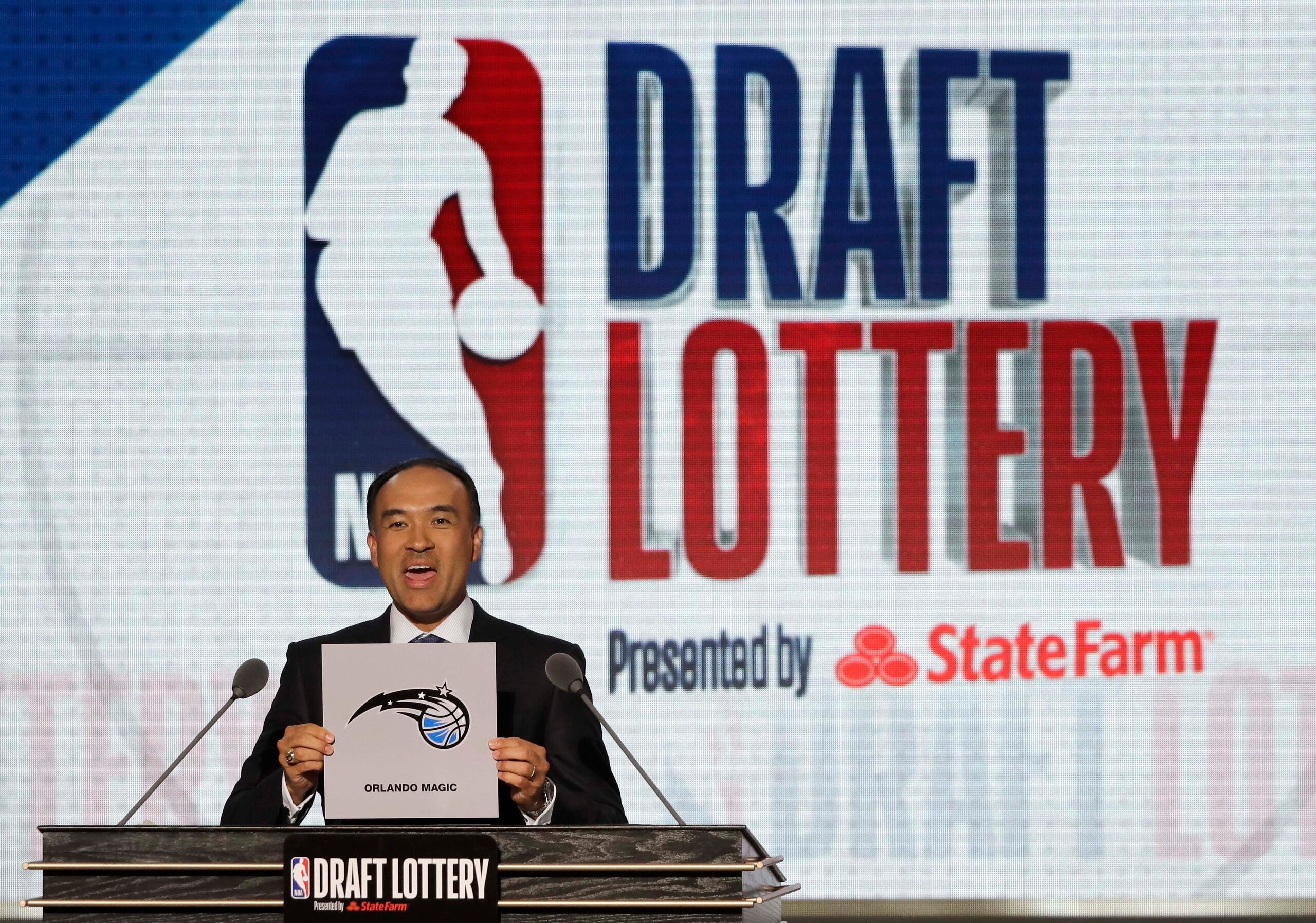 NBA Deputy Commissioner Mark Tatum announces that the Orlando Magic hadwon the sixth pick during the NBA basketball draft lottery Tuesday, May 15, 2018, in Chicago. (AP Photo/Charles Rex Arbogast)