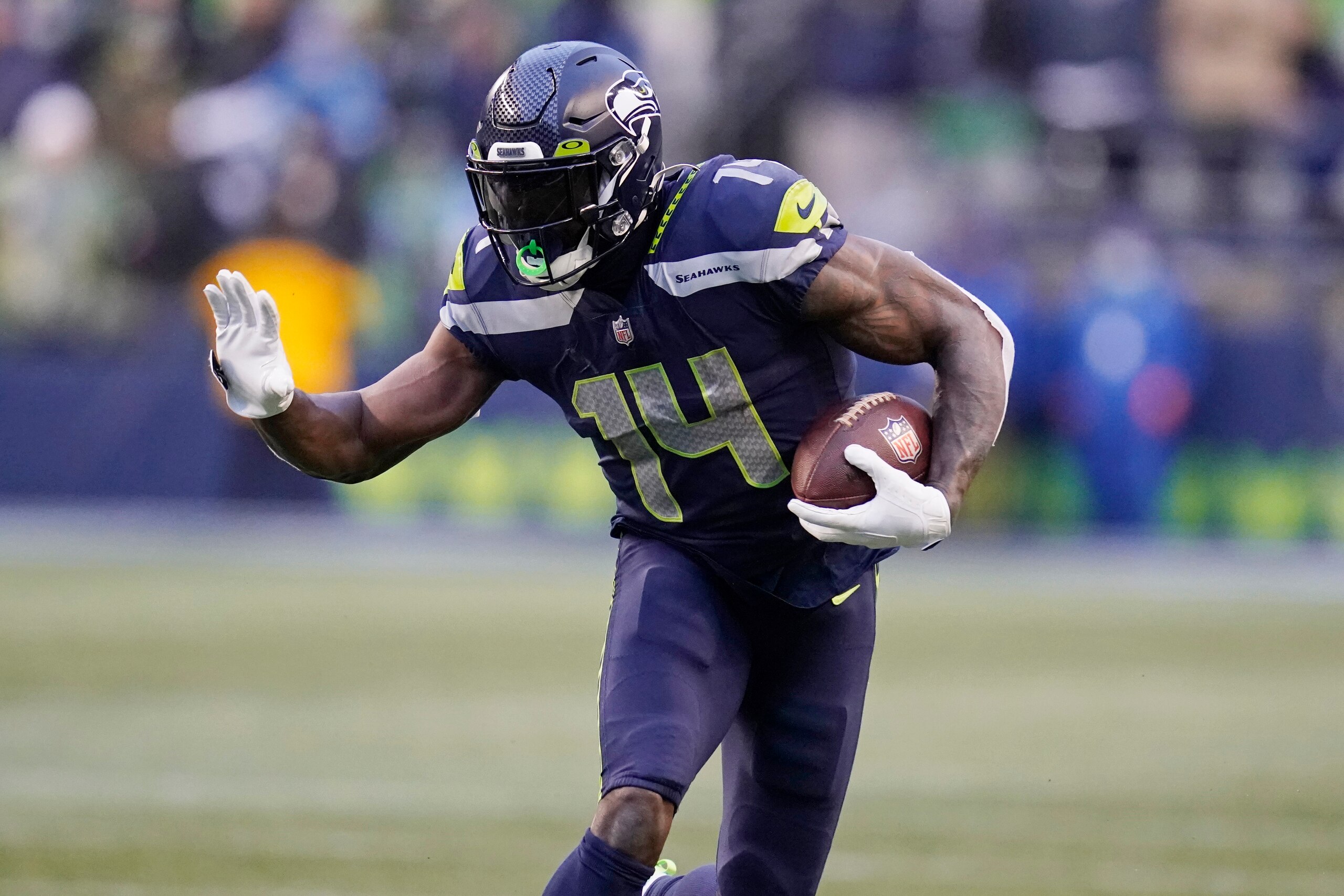 Seattle Seahawks wide receiver DK Metcalf carries the ball against the Detroit Lions during the second half of an NFL football game, Sunday, Jan. 2, 2022, in Seattle. (AP Photo/Elaine Thompson)