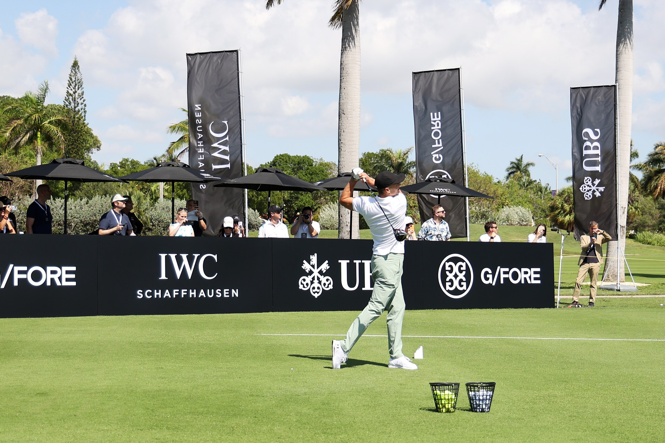 MIAMI BEACH, FLORIDA - MAY 04: IWC brand ambassador and seven-time World Champion quarterback Tom Brady hits a gold ball during The Big Pilot Challenge, an entertaining charity golf challenge organized by IWC Schaffhausen at the Miami Beach Golf Club on May 4, 2022 in Miami Beach, Florida. (Photo by John Parra/Getty Images for IWC Schaffhausen)
