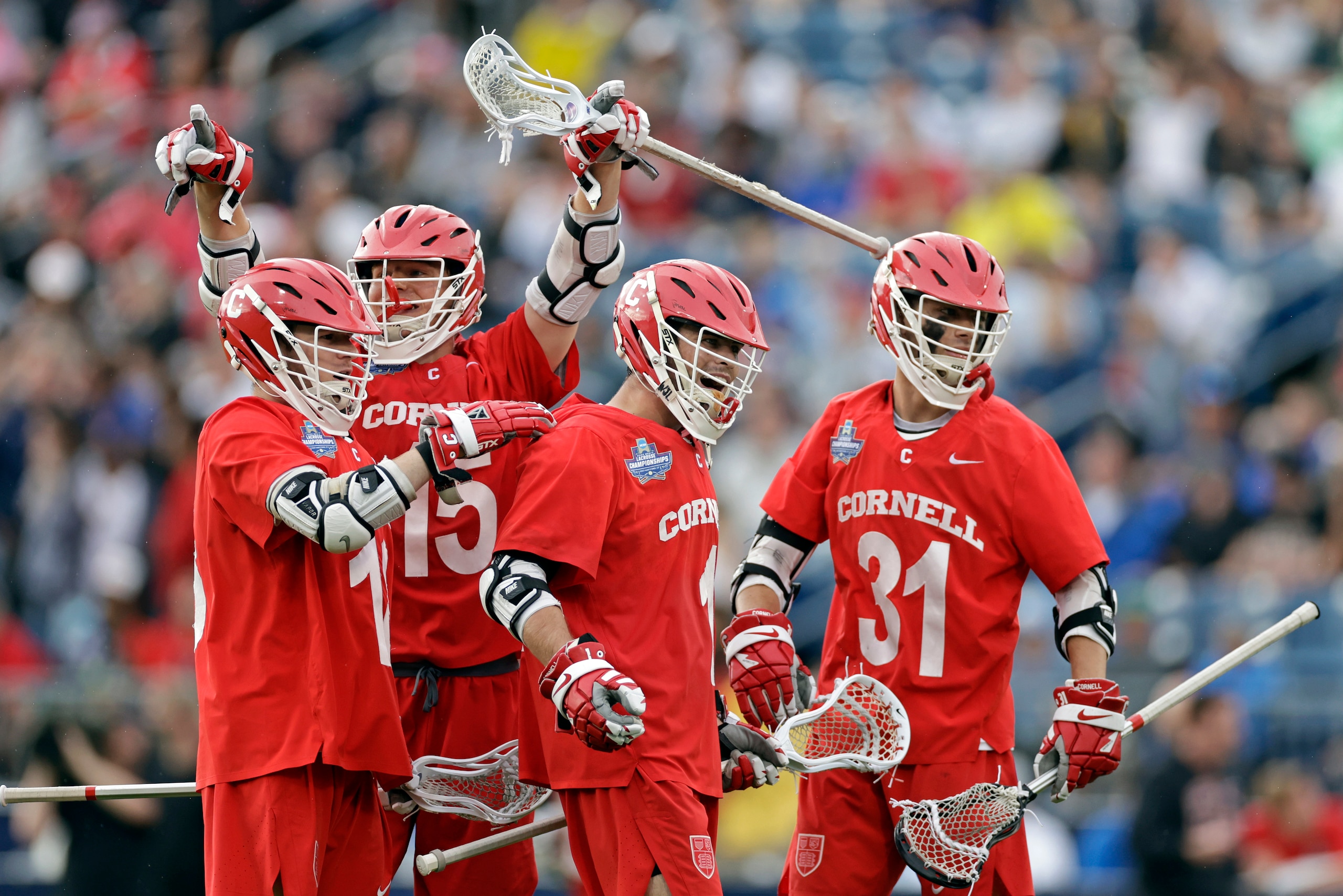 Cornell attack Michael Long, second from right, is congratulated by teammates after scoring a goal against the Rutgers during the second half of an NCAA college lacrosse semifinal game, Saturday, May 28, 2022, in East Hartford, Conn. (AP Photo/Adam Hunger)