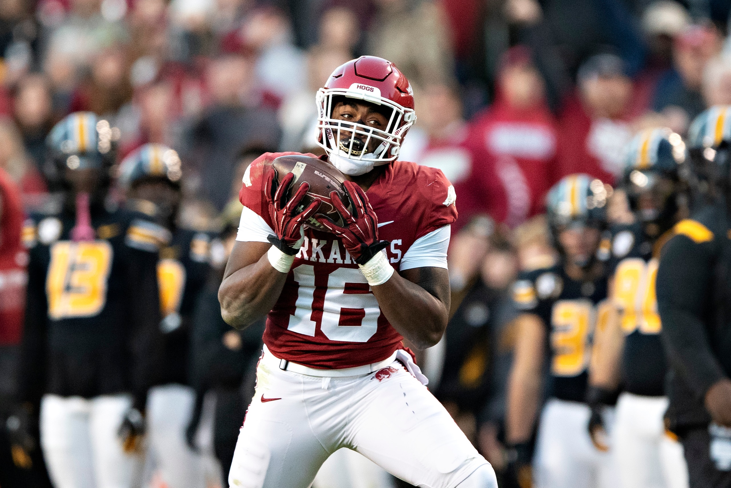 FAYETTEVILLE, ARKANSAS - NOVEMBER 26: Treylon Burks #16 of the Arkansas Razorbacks catches a pass for a touchdown during a game against the Missouri Tigers at Donald W. Reynolds Razorback Stadium on November 26, 2021 in Fayetteville, Arkansas. The Razorbacks defeated the Tigers 34-17.  (Photo by Wesley Hitt/Getty Images)