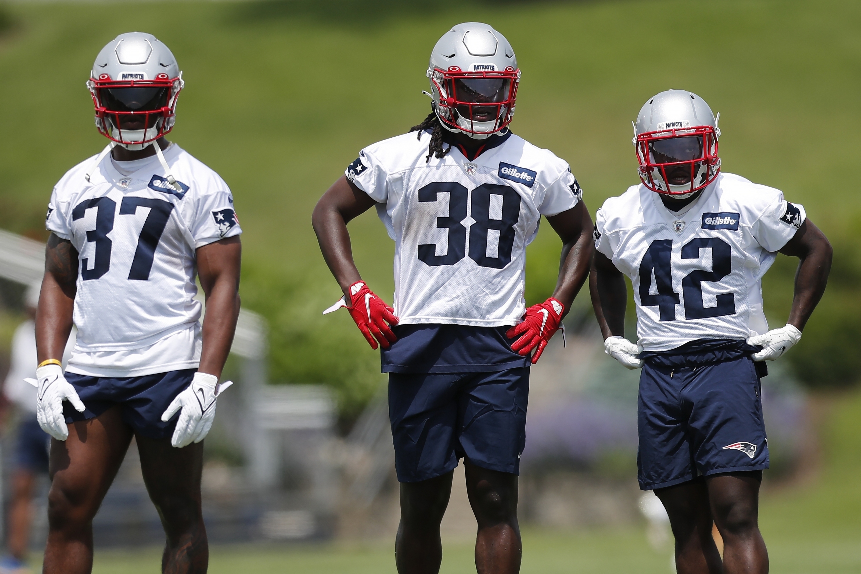 New England Patriots running backs Damien Harris (37), Rhamondre Stevenson (38) and J.J. Taylor (42) take part in drills at the NFL football team's practice facility in Foxborough, Mass., Tuesday, May 31, 2022 (AP Photo/Michael Dwyer)