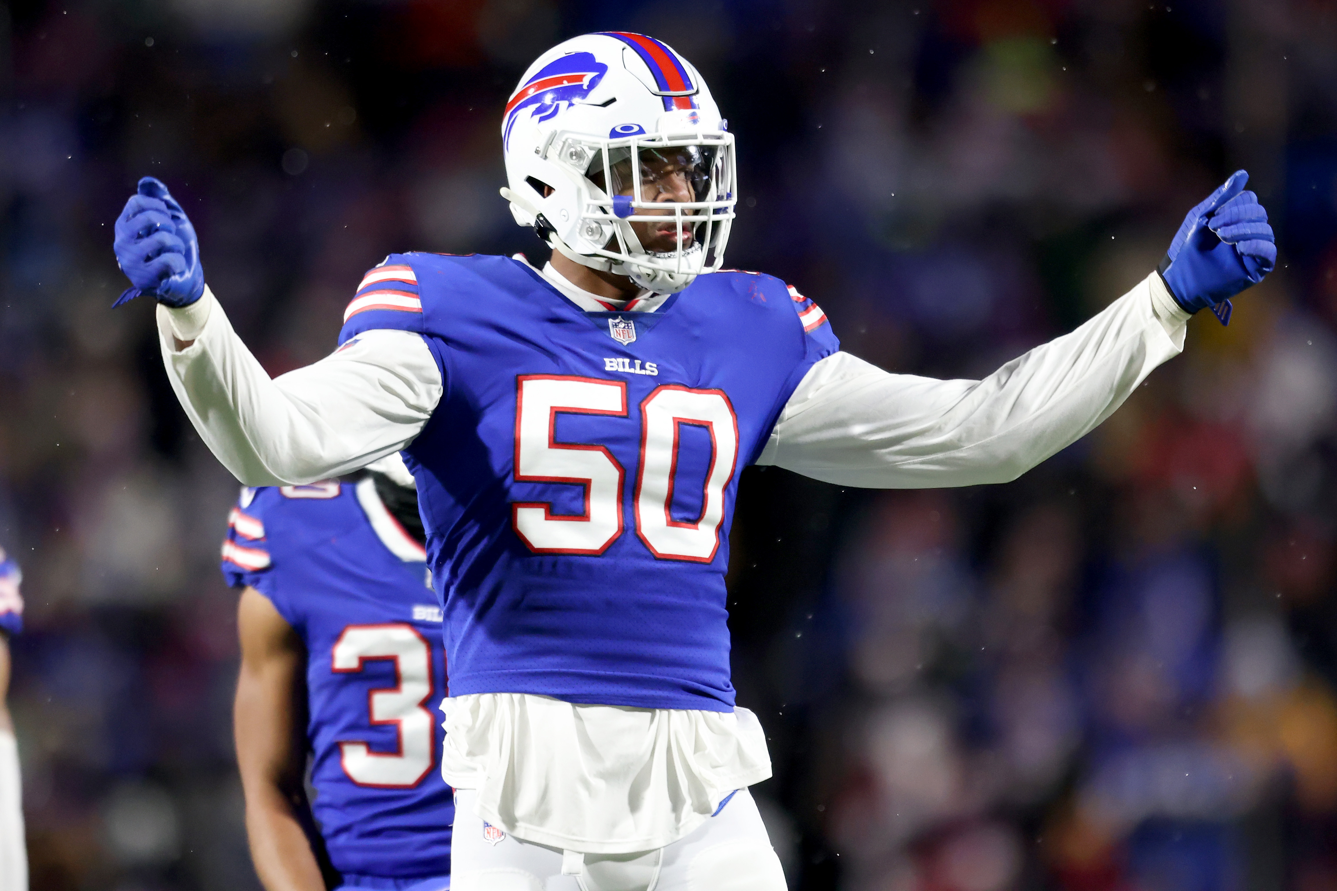 Miami edge rusher Gregory Rousseau, right, holds a team jersey with NFL  Commissioner Roger Goodell after the Buffalo Bills selected Rousseau with  the 30th pick in the first round of the NFL