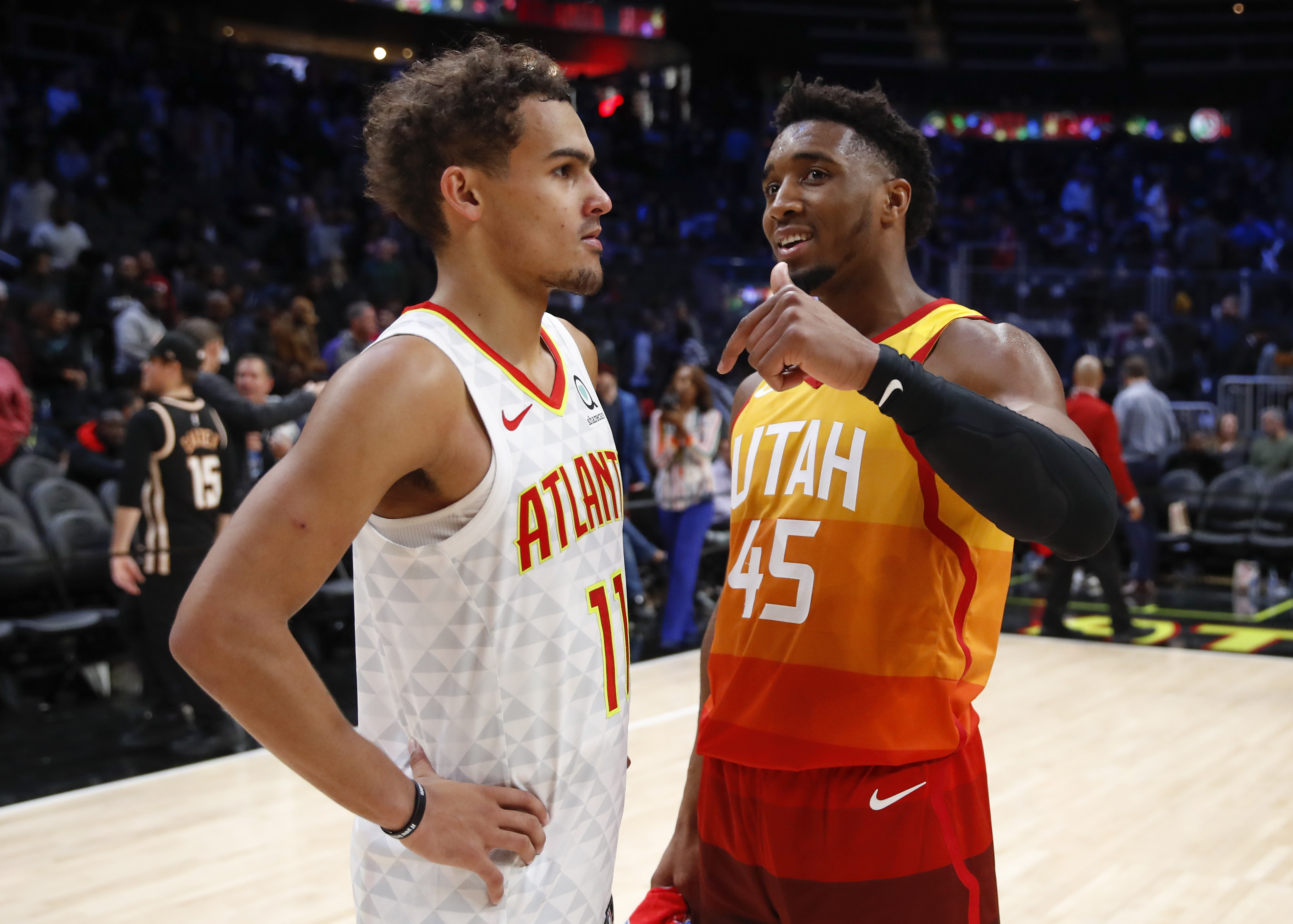 ATLANTA, GA - DECEMBER 19: Donovan Mitchell #45 of the Utah Jazz speaks with Trae Young #11 of the Atlanta Hawks at the conclusion of an NBA game at State Farm Arena on December 19, 2019 in Atlanta, Georgia. NOTE TO USER: User expressly acknowledges and agrees that, by downloading and/or using this photograph, user is consenting to the terms and conditions of the Getty Images License Agreement. (Photo by Todd Kirkland/Getty Images)