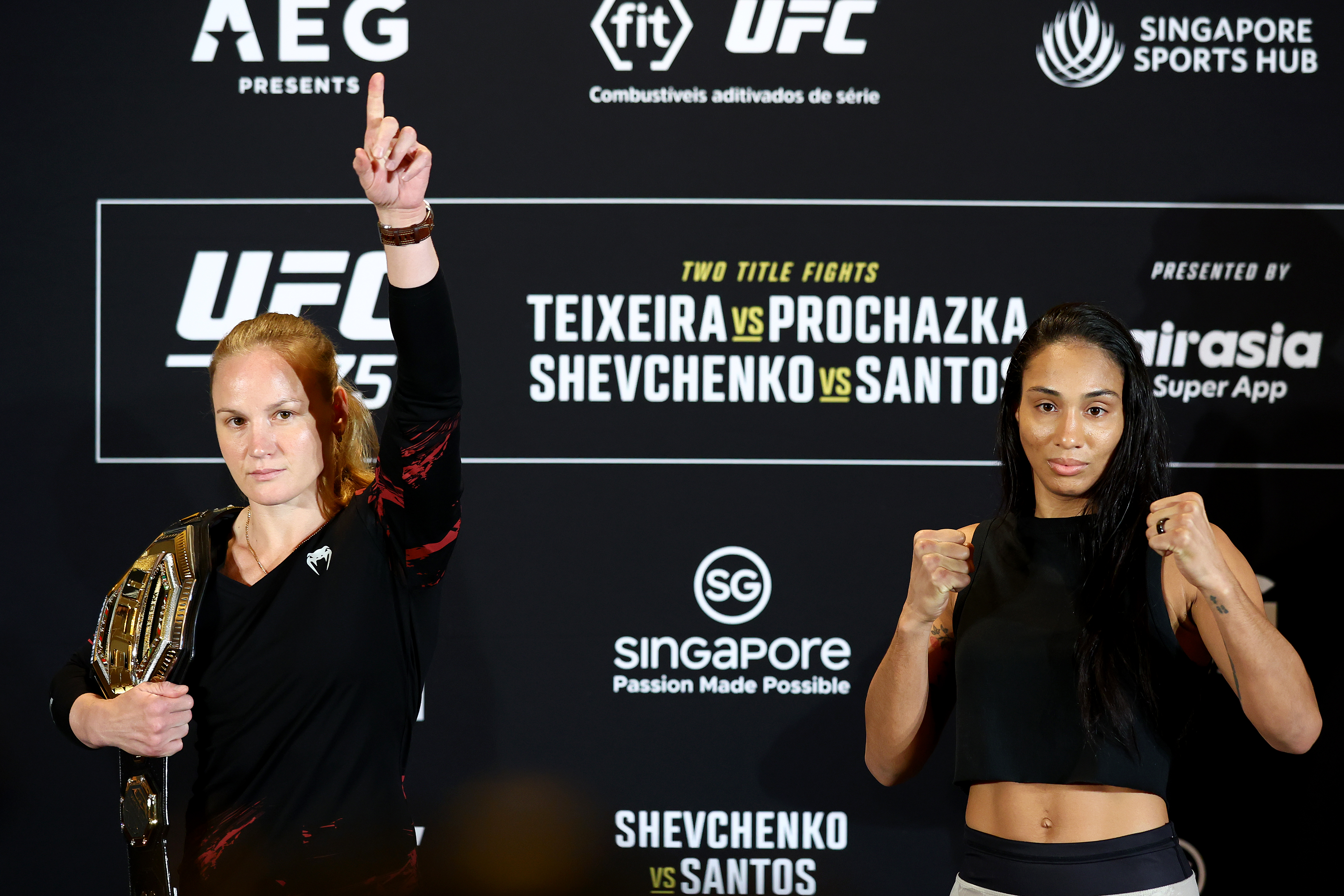 SINGAPORE, SINGAPORE - JUNE 08: UFC flyweight champion Valentina Shevchenko (L) of Kyrgyzstan and Taila Santos of Brazil pose for photos ahead of their title bout during UFC 275 Media Day at Mandarin Oriental on June 08, 2022 in Singapore. (Photo by Yong Teck Lim/Getty Images)