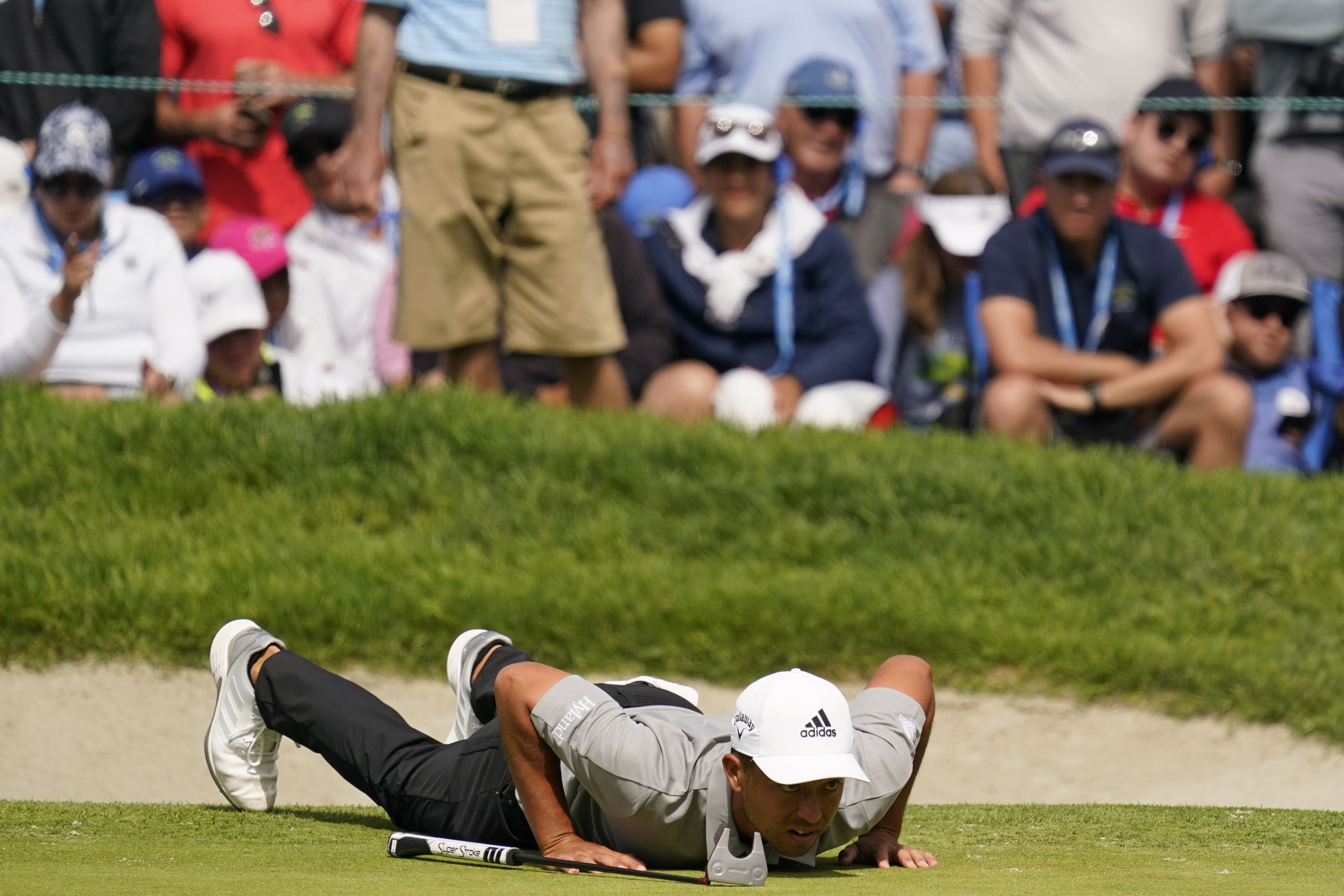 Xander Schauffele lines up his shot on the 18th green during the final round of the U.S. Open Golf Championship, Sunday, June 20, 2021, at Torrey Pines Golf Course in San Diego. (AP Photo/Gregory Bull)