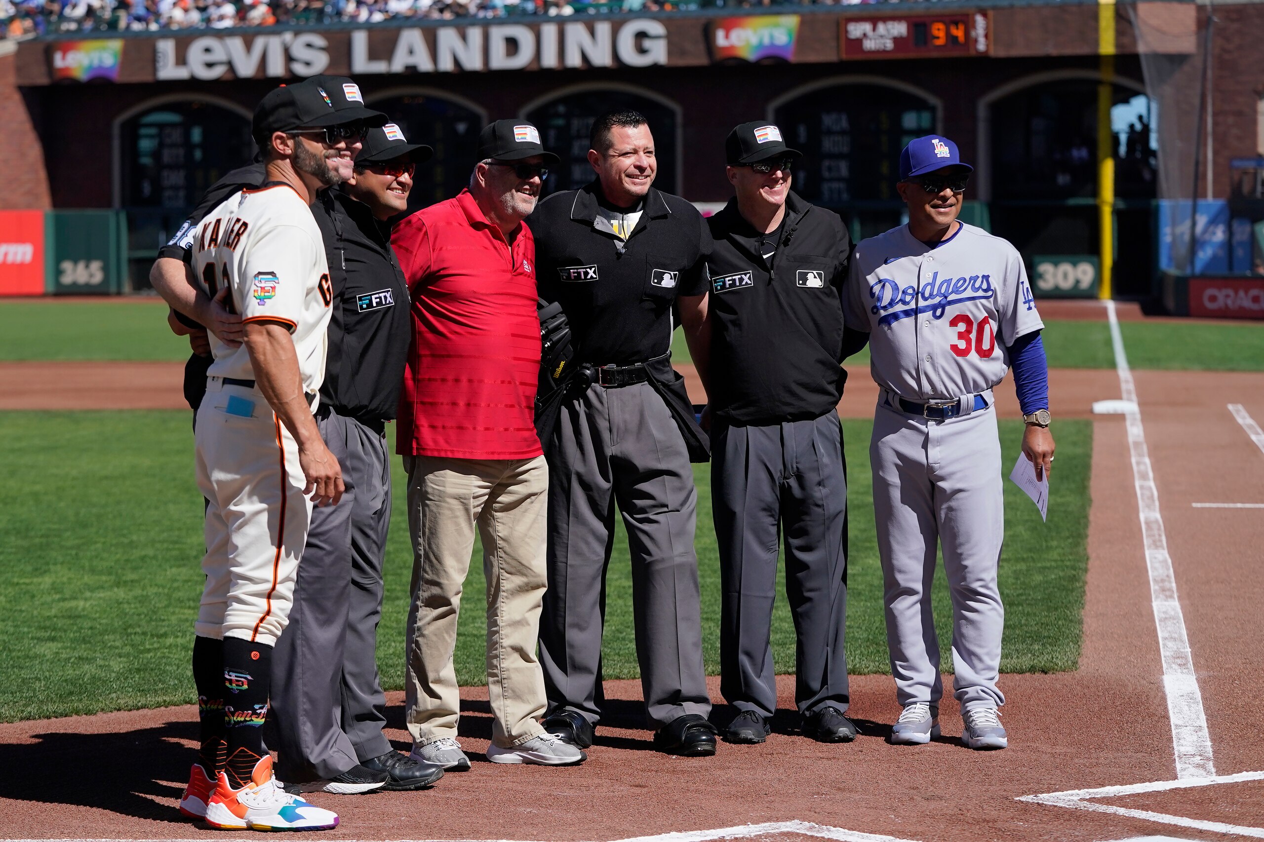 Former umpire Dale Scott, middle left, poses for photos with San Francisco Giants manager Gabe Kapler, left, Los Angeles Dodgers manager Dave Roberts, right, and the umpiring crew after the lineup-card exchange on Pride Day at Oracle Park before a baseball game between the Giants and the Dodgers in San Francisco, Saturday, June 11, 2022. (AP Photo/Jeff Chiu) Former umpire Dale Scott, middle left, poses for photos with San Francisco Giants manager Gabe Kapler, left, Los Angeles Dodgers manager Dave Roberts, right, and the umpiring crew after the lineup-card exchange on Pride Day at Oracle Park before a baseball game between the Giants and the Dodgers in San Francisco, Saturday, June 11, 2022. (AP Photo/Jeff Chiu)