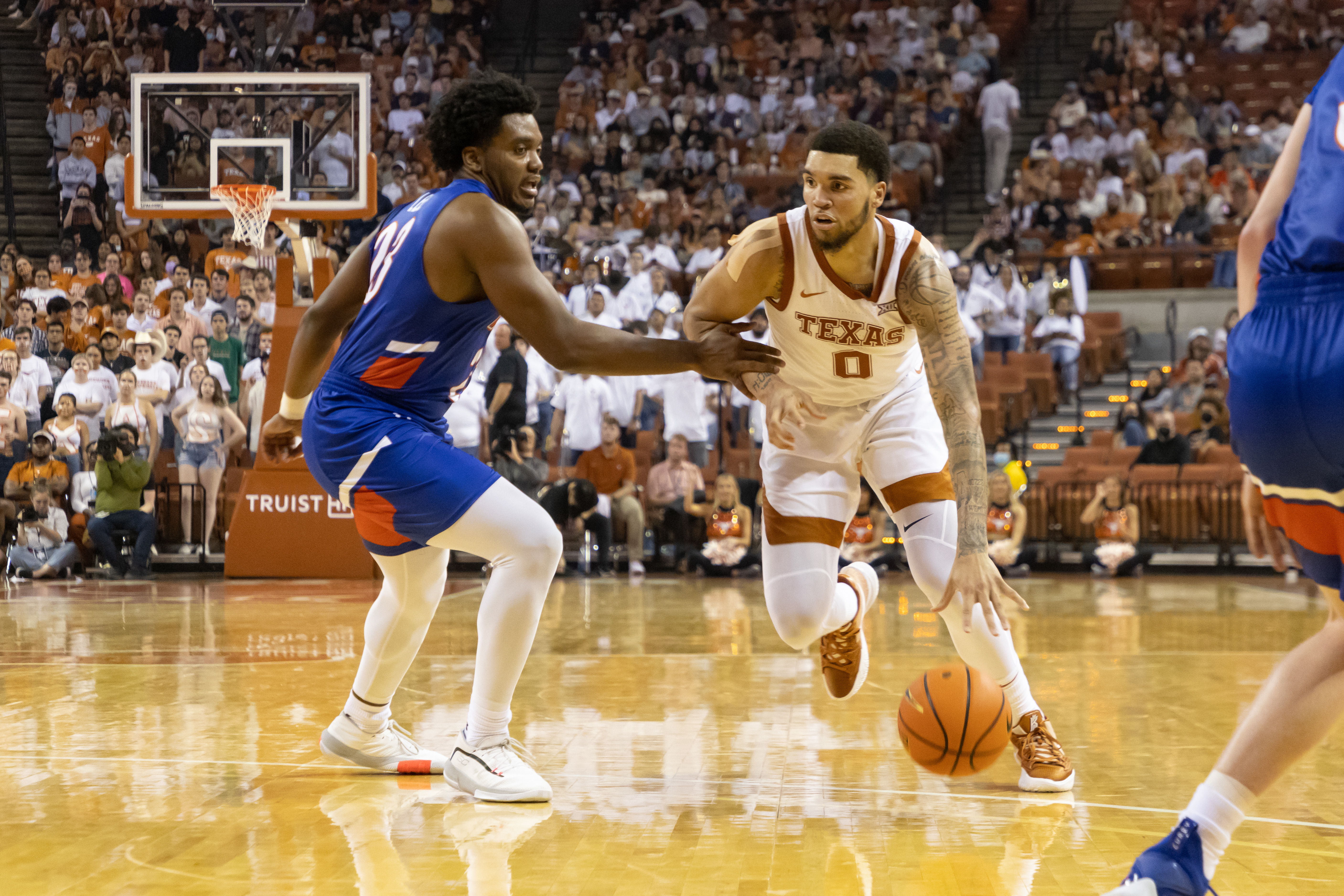 AUSTIN, TX - NOVEMBER 09: Timmy Allen (0) of the Texas Longhorns drives past Darius Lee (23) of the Houston Baptist Huskies game between the Texas Longhorns and the Houston Baptist Huskies at Frank Erwin Center in Austin, TX on November 9, 2021. (Photo by David Buono/Icon Sportswire via Getty Images)