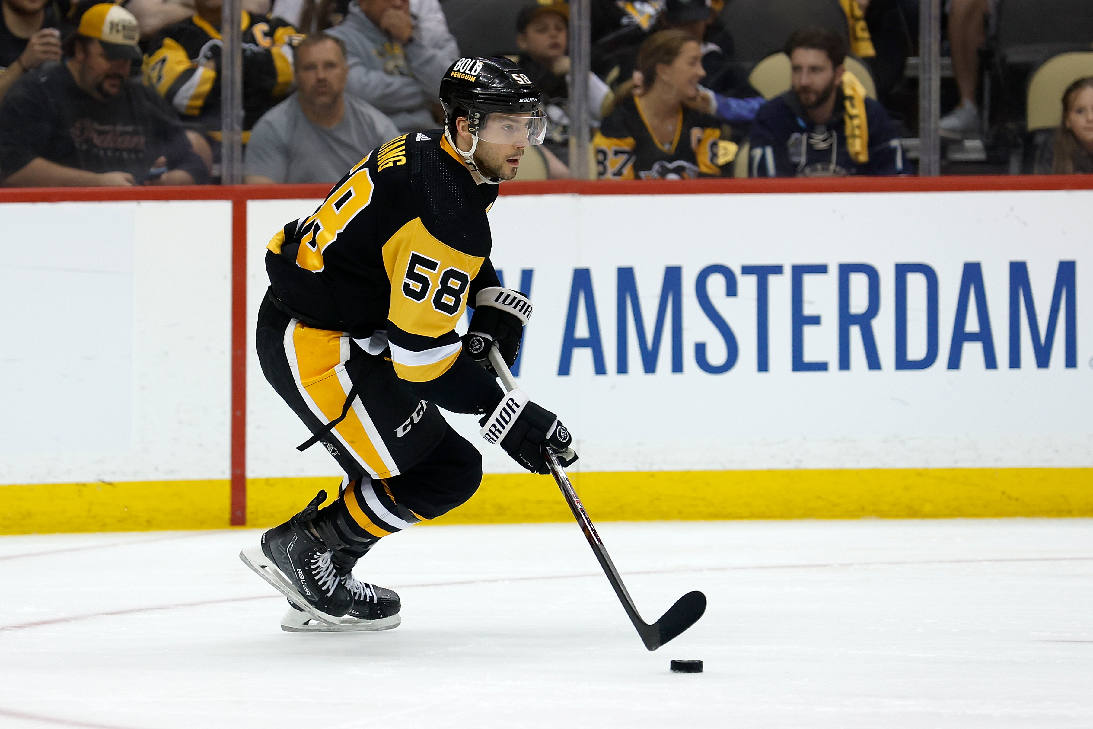 PITTSBURGH, PA - MAY 13: Kris Letang #58 of the Pittsburgh Penguins controls the puck in Game Six of the First Round of the 2022 Stanley Cup Playoffs against the New York Rangers at PPG PAINTS Arena on May 13, 2022 in Pittsburgh, Pennsylvania. (Photo by Kirk Irwin/Getty Images)