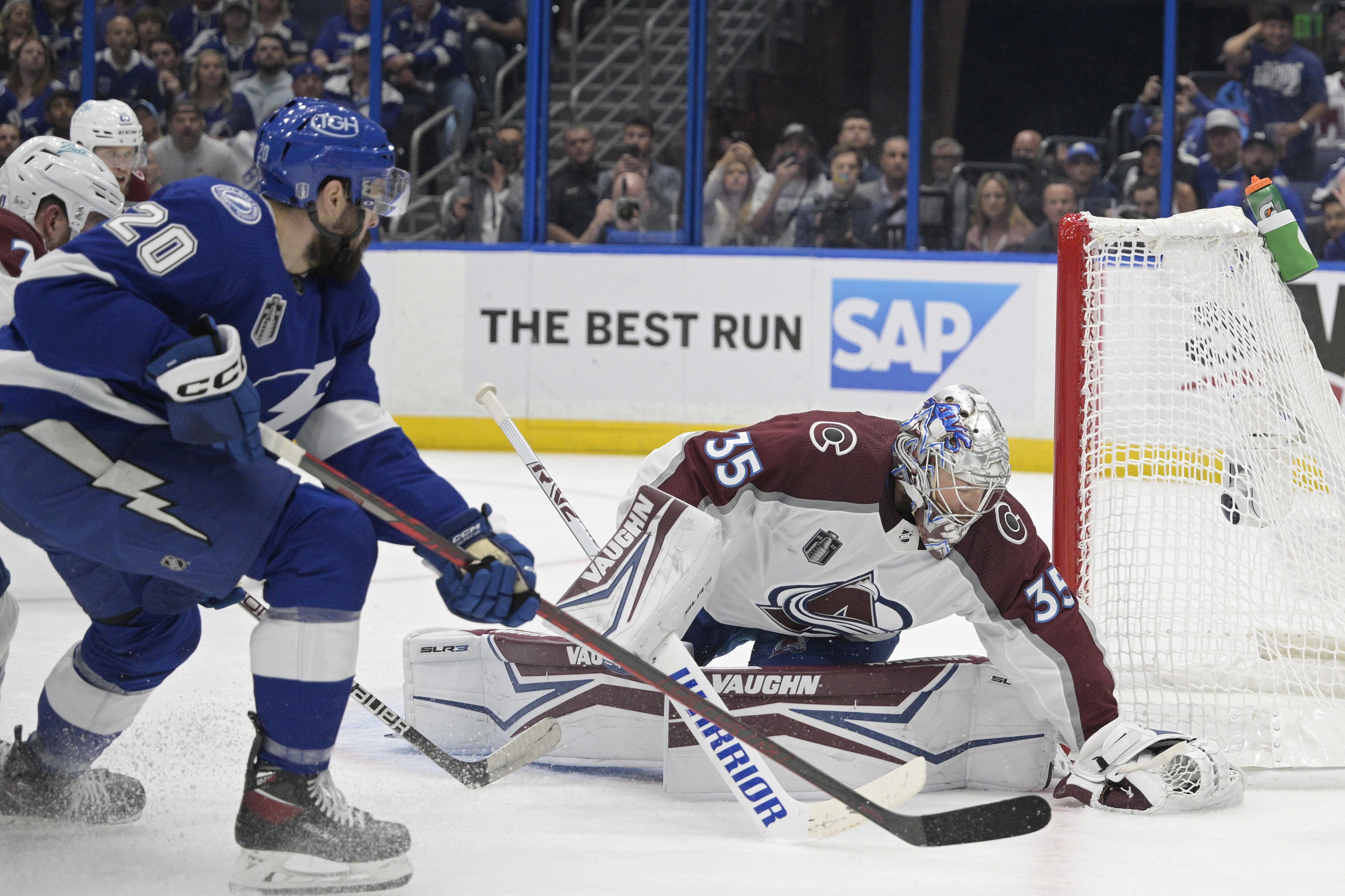 Colorado Avalanche goaltender Darcy Kuemper (35) makes a save in front of Tampa Bay Lightning left wing Nicholas Paul (20) during the first period of Game 4 of the NHL hockey Stanley Cup Finals on Wednesday, June 22, 2022, in Tampa, Fla. (AP Photo/Phelan Ebenhack)