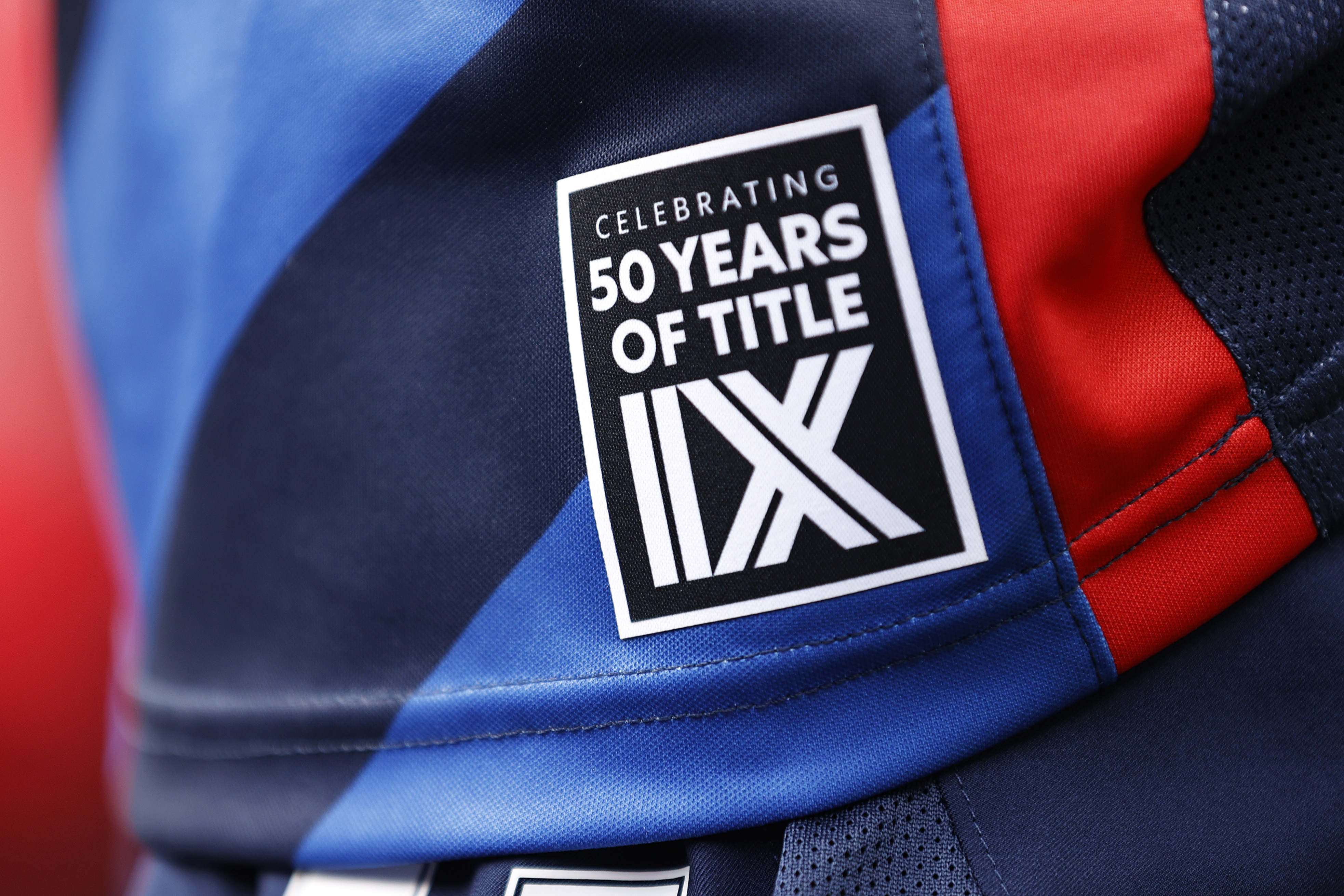 SEATTLE, WASHINGTON - MAY 22: A patch celebrating 50 years of Title IX is seen on the jersey of Sam Hiatt #17 of OL Reign after the game against the Washington Spirit at Lumen Field on May 22, 2022 in Seattle, Washington. (Photo by Steph Chambers/Getty Images)