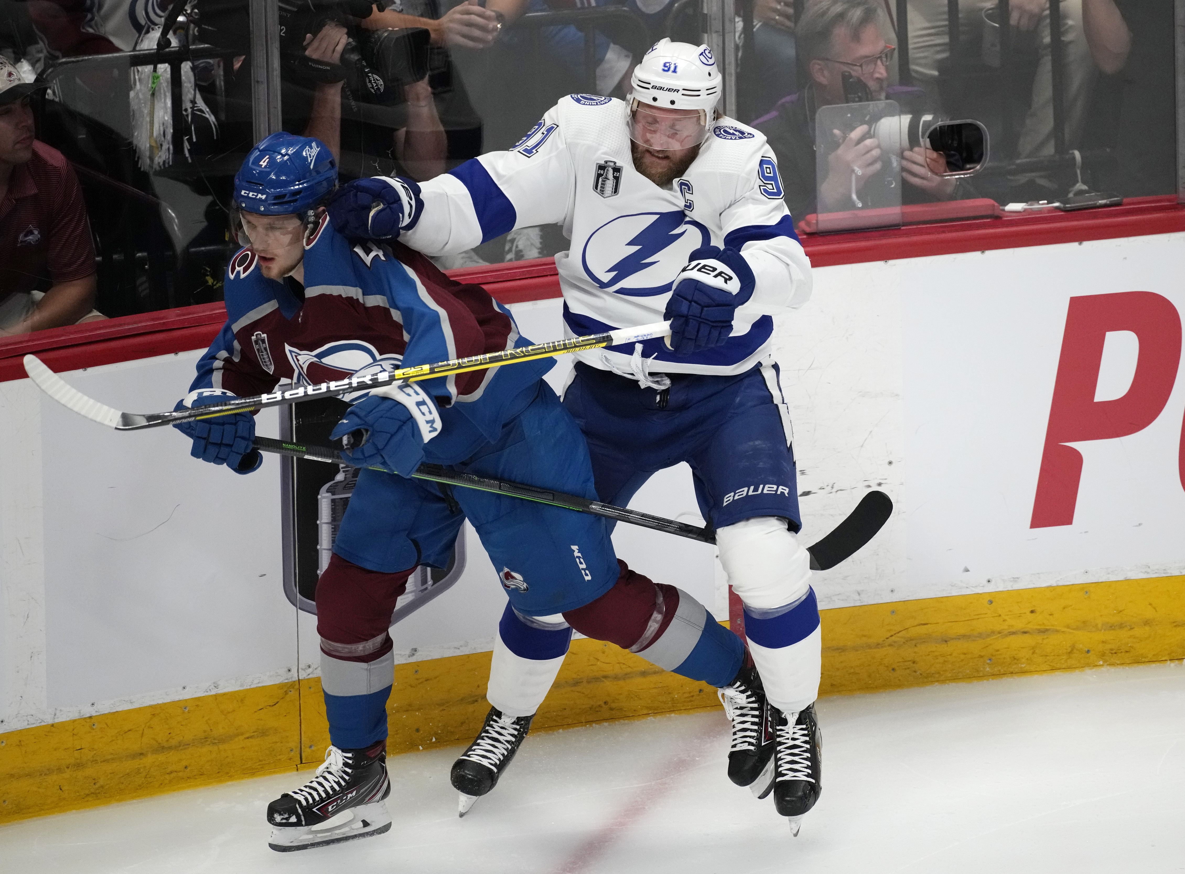 Tampa Bay Lightning center Steven Stamkos, right, checks Colorado Avalanche defenseman Bowen Byram during the first period of Game 5 of the NHL hockey Stanley Cup Final on Friday, June 24, 2022, in Denver. (AP Photo/David Zalubowski)
