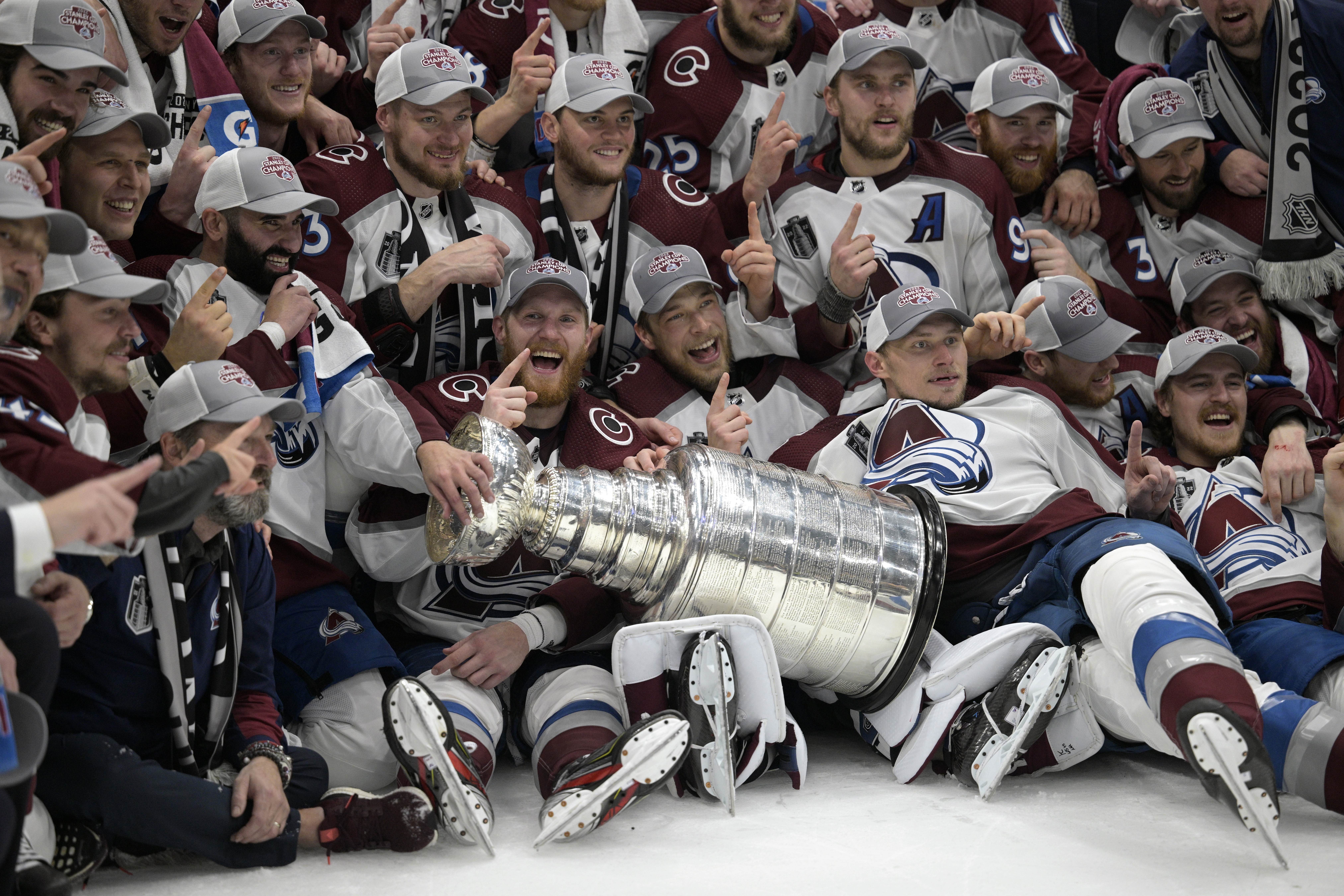 Colorado Avalanche players pose with the Stanley Cup after the team defeated the Tampa Bay Lightning in Game 6 of the NHL hockey Stanley Cup Finals on Sunday, June 26, 2022, in Tampa, Fla. (AP Photo/Phelan M. Ebenhack)