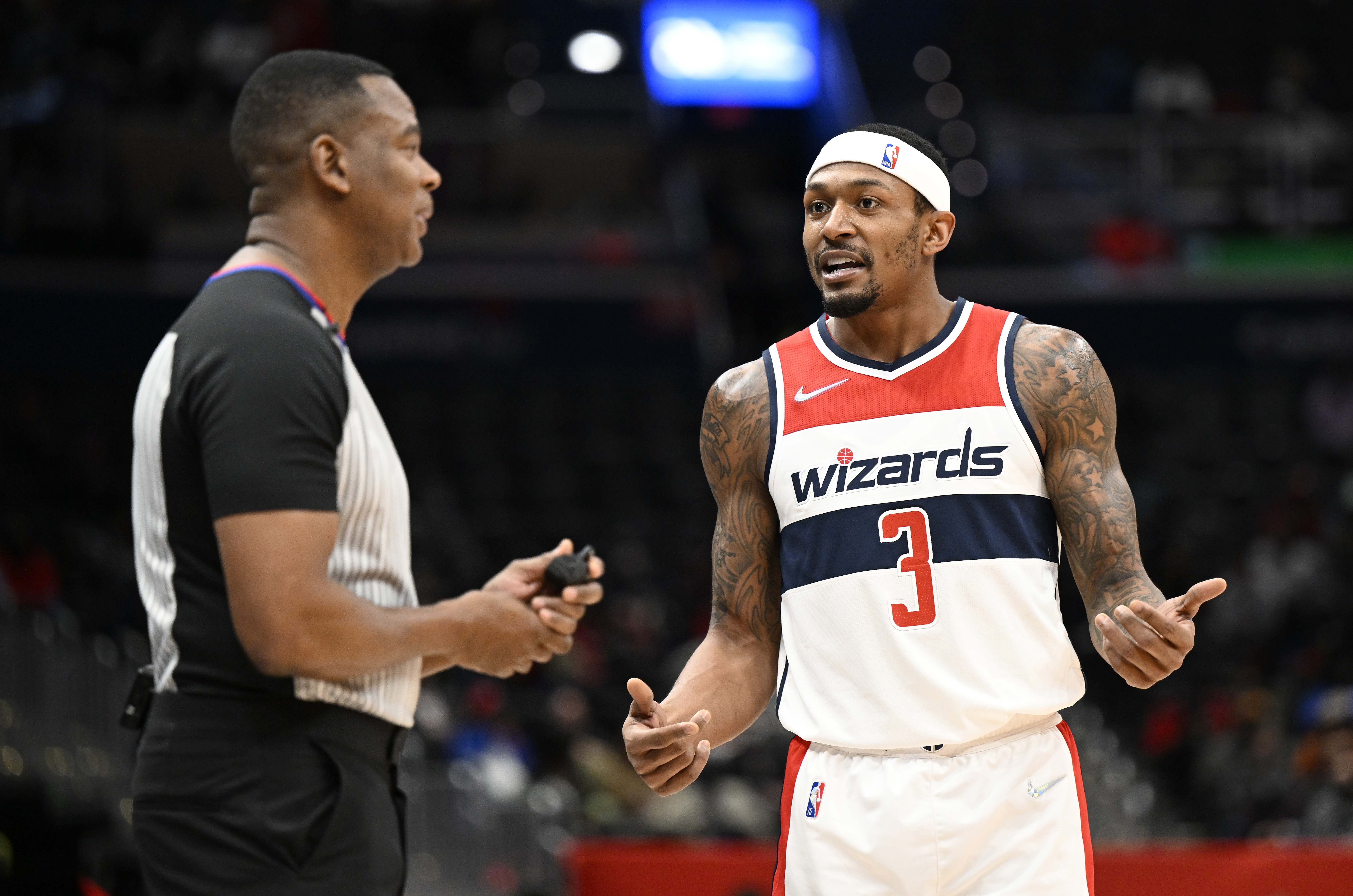 WASHINGTON, DC - JANUARY 25: Bradley Beal #3 of the Washington Wizards talks with official Sean Wright #4 during the game against the LA Clippers at Capital One Arena on January 25, 2022 in Washington, DC. NOTE TO USER: User expressly acknowledges and agrees that, by downloading and or using this photograph, User is consenting to the terms and conditions of the Getty Images License Agreement. (Photo by G Fiume/Getty Images)