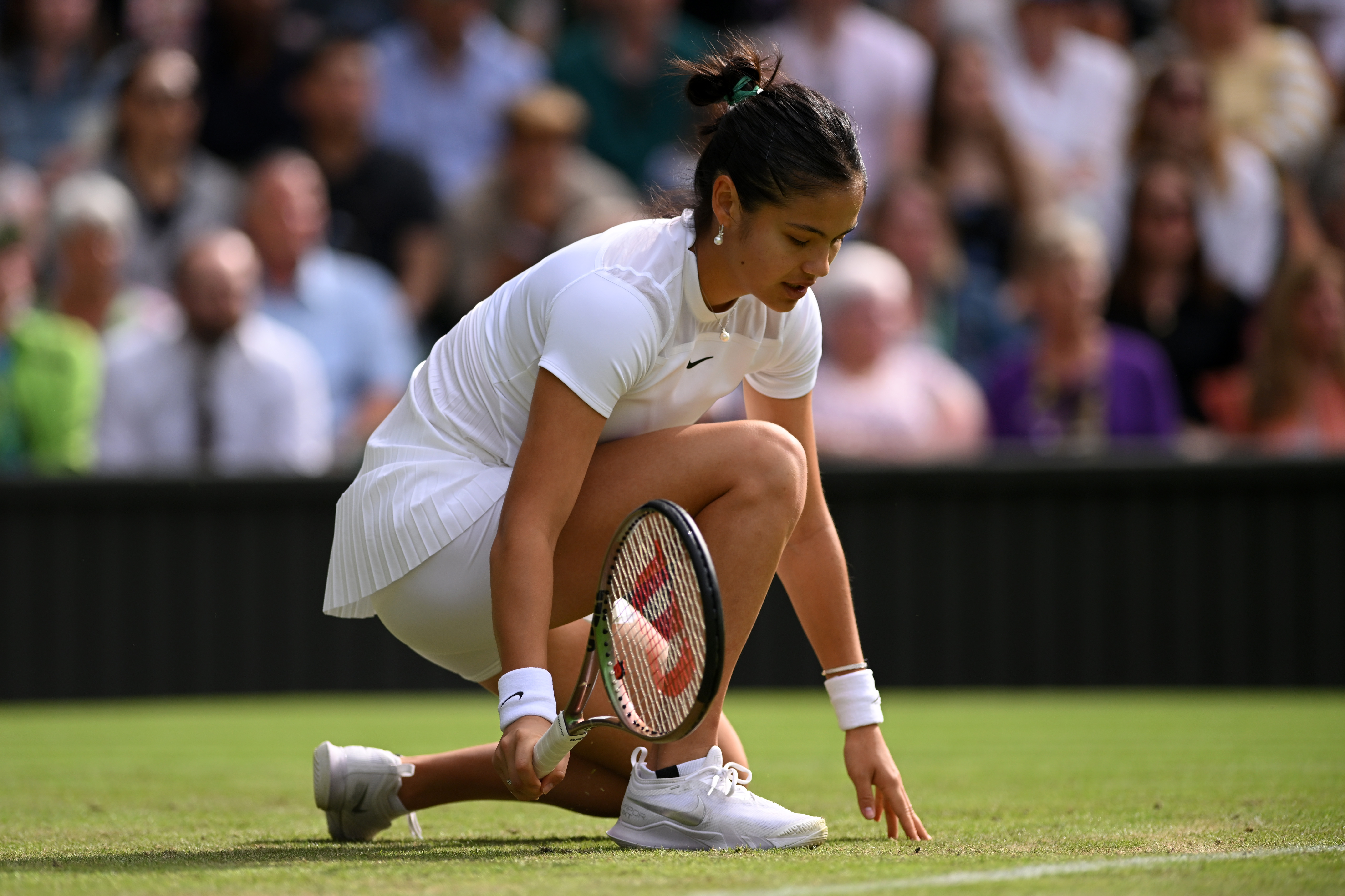 LONDON, ENGLAND - JUNE 29: Emma Raducanu of Great Britain reacts against Caroline Garcia of France during their Women's Singles Second Round match on day three of The Championships Wimbledon 2022 at All England Lawn Tennis and Croquet Club on June 29, 2022 in London, England. (Photo by Shaun Botterill/Getty Images)
