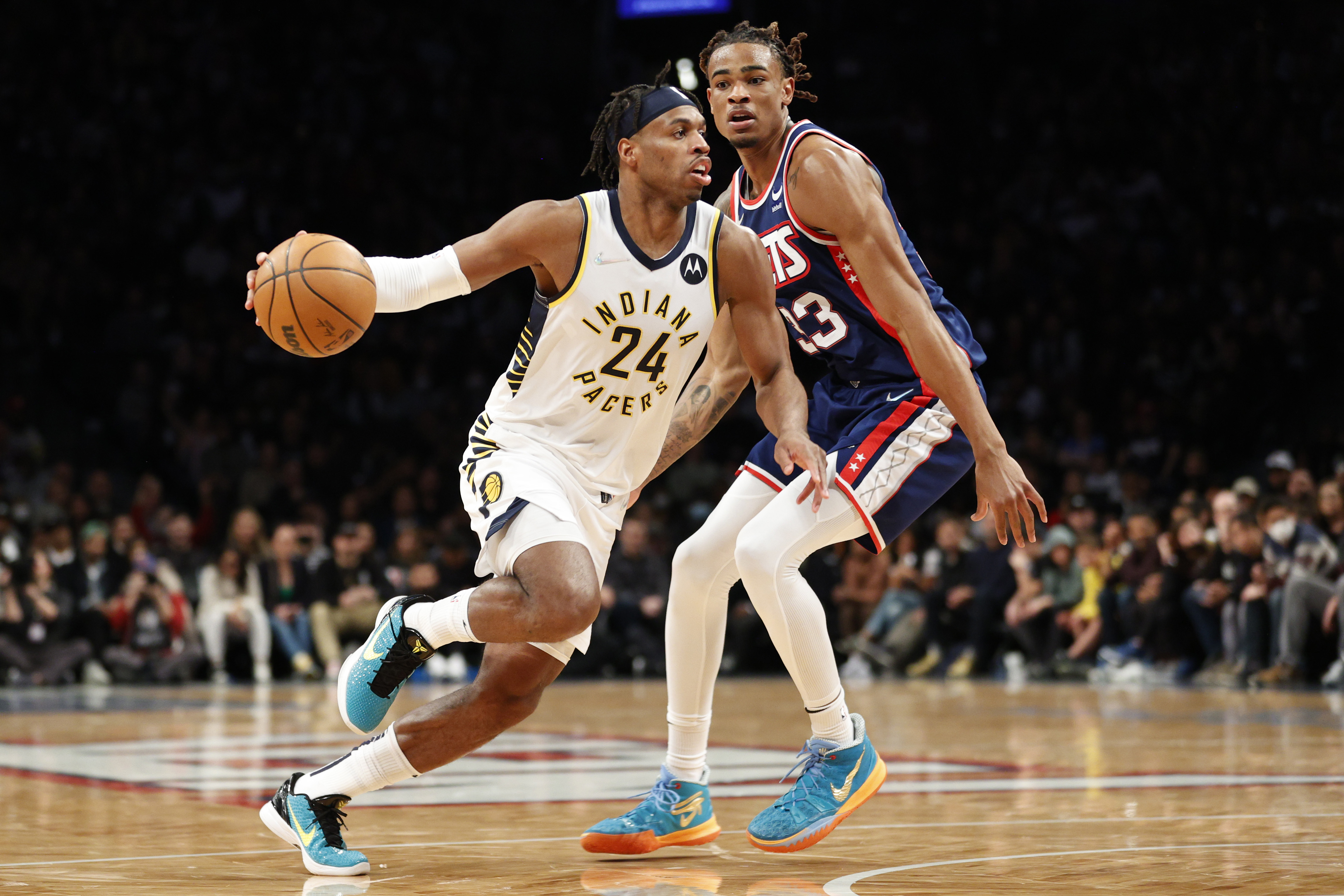 NEW YORK, NEW YORK - APRIL 10: Buddy Hield #24 of the Indiana Pacers dribbles as Nic Claxton #33 of the Brooklyn Nets defends during the second half at Barclays Center on April 10, 2022 in the Brooklyn borough of New York City. The Nets won 134-126. NOTE TO USER: User expressly acknowledges and agrees that, by downloading and or using this photograph, User is consenting to the terms and conditions of the Getty Images License Agreement. (Photo by Sarah Stier/Getty Images)