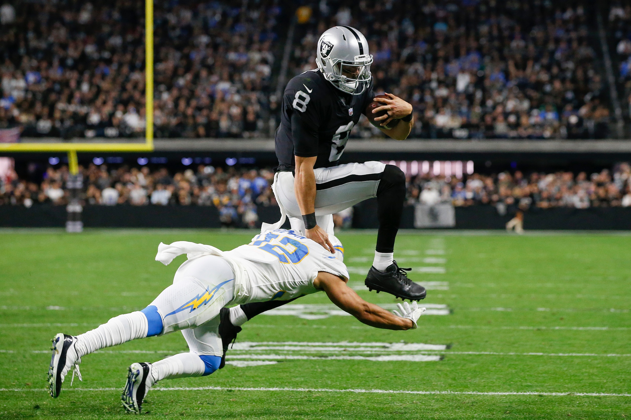 LAS VEGAS, NEVADA - JANUARY 09: Alohi Gilman #32 of the Los Angeles Chargers tackles Marcus Mariota #8 of the Las Vegas Raiders during the fourth quarter at Allegiant Stadium on January 09, 2022 in Las Vegas, Nevada. (Photo by Steve Marcus/Getty Images)
