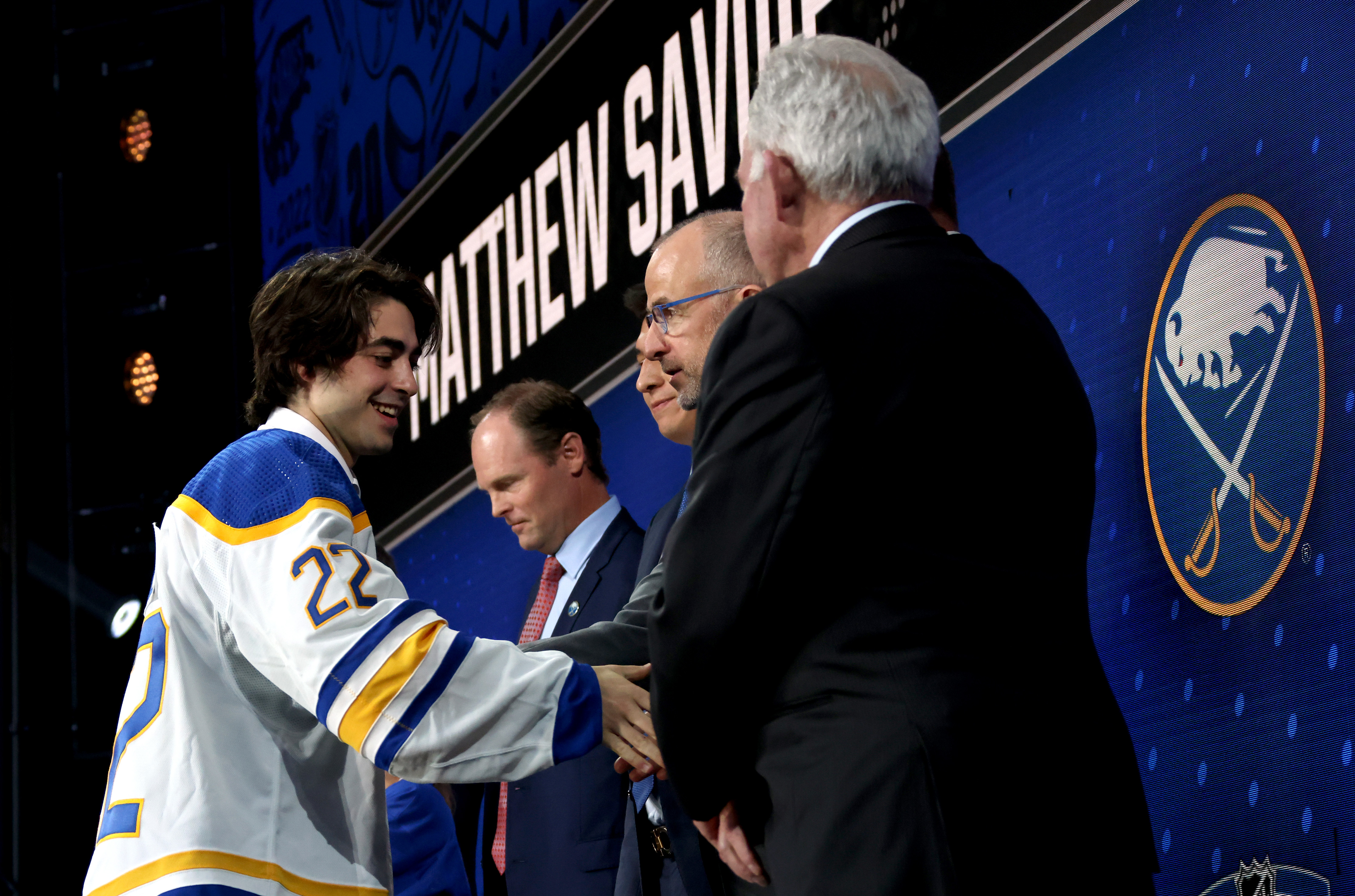 MONTREAL, QUEBEC - JULY 07: Matthew Savoie shakes hands onstage with team personnel after being selected ninth overall by the Buffalo Sabres during the first round of the 2022 Upper Deck NHL Draft at Bell Centre on July 07, 2022 in Montreal, Quebec. (Photo by Dave Sandford/NHLI via Getty Images)