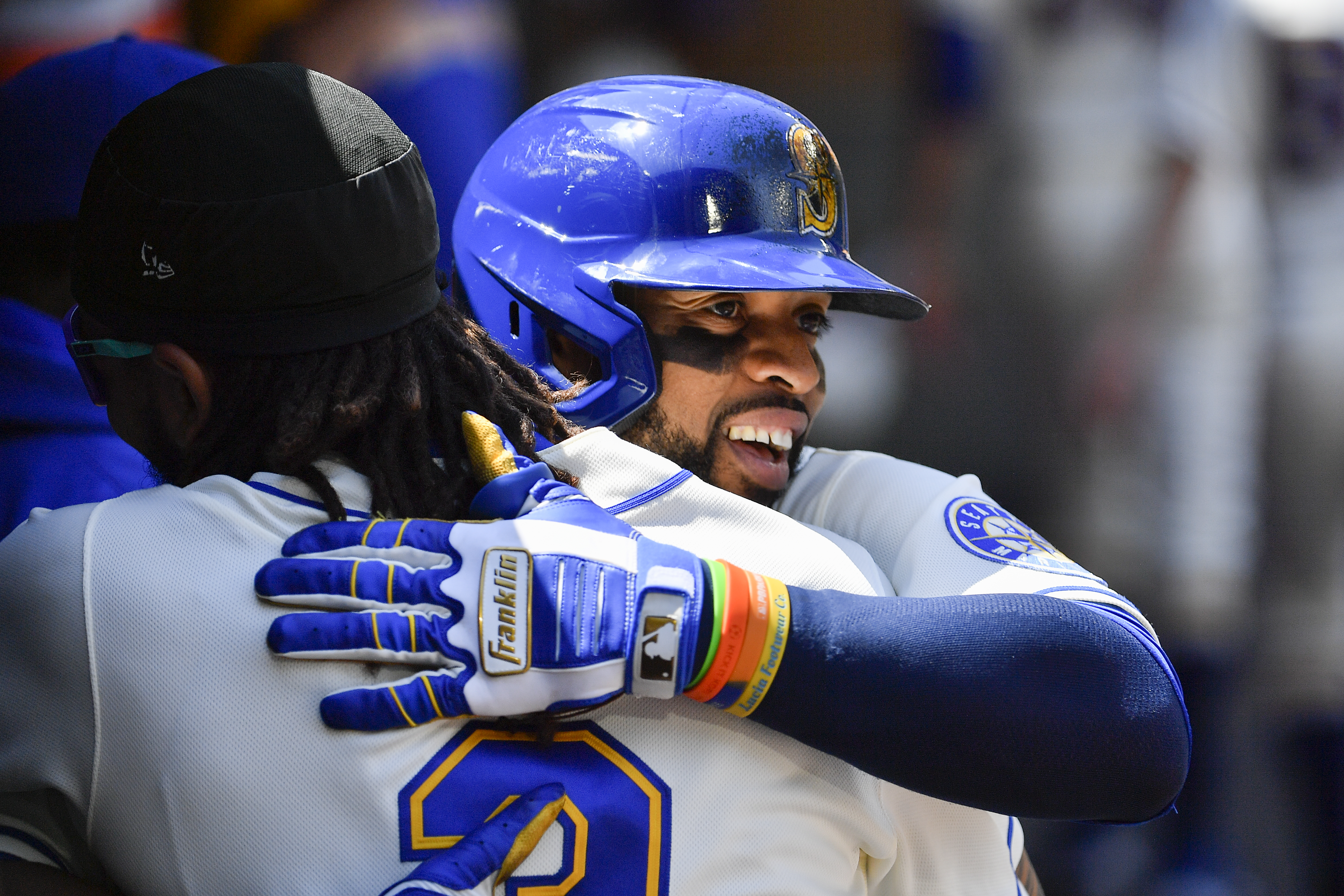 SEATTLE, WASHINGTON - JULY 10: Carlos Santana #41 of the Seattle Mariners and J.P. Crawford #3 hug after Santana's solo home run during the second inning against the Toronto Blue Jays at T-Mobile Park on July 10, 2022 in Seattle, Washington. (Photo by Alika Jenner/Getty Images)