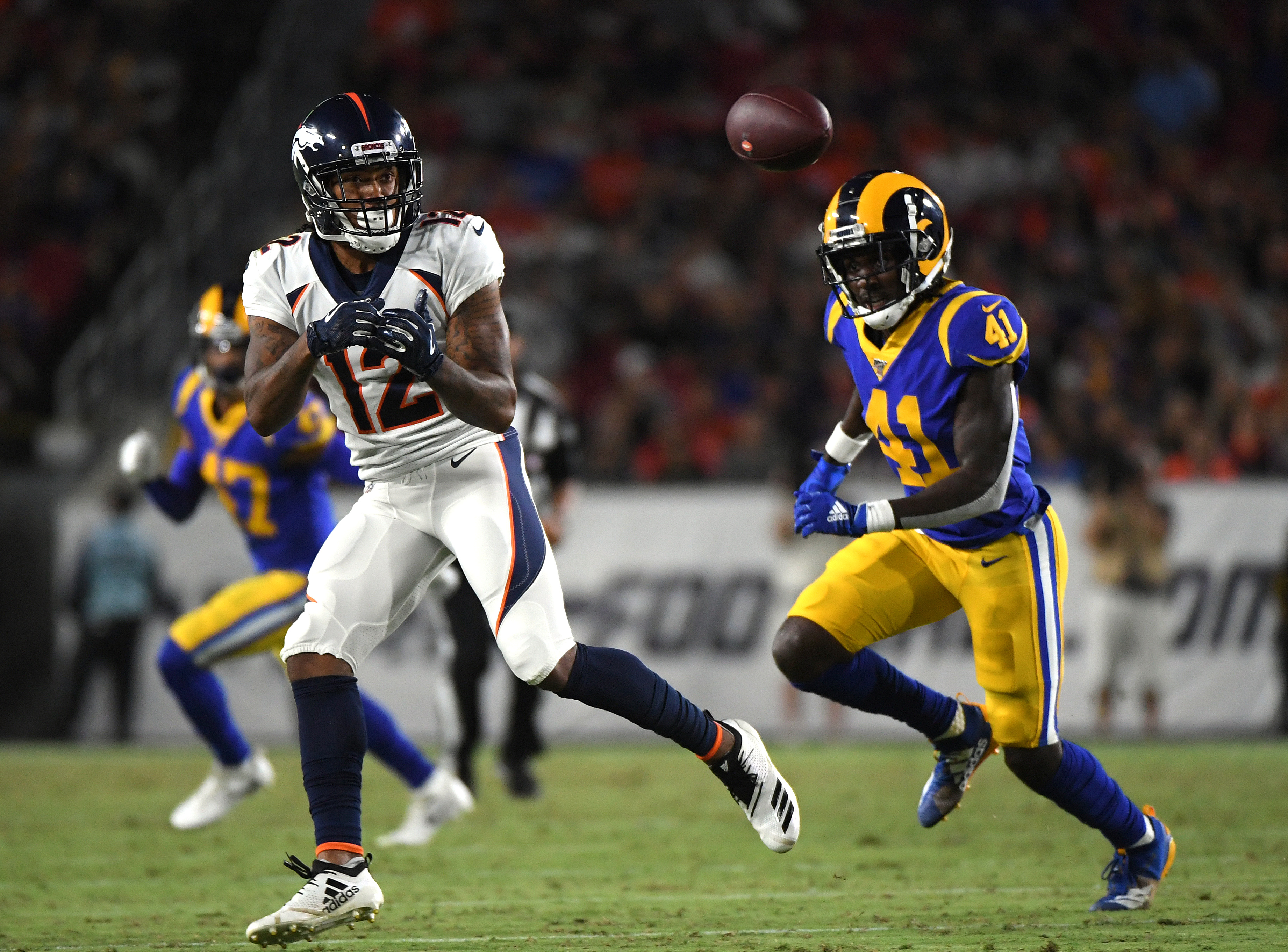 LOS ANGELES, CALIFORNIA - AUGUST 24: Brendan Langley #12 of the Denver Broncos prepares for a catch in front of David Long #41 of the Los Angeles Rams during second half of a preseason game at Los Angeles Memorial Coliseum on August 24, 2019 in Los Angeles, California. (Photo by Harry How/Getty Images)