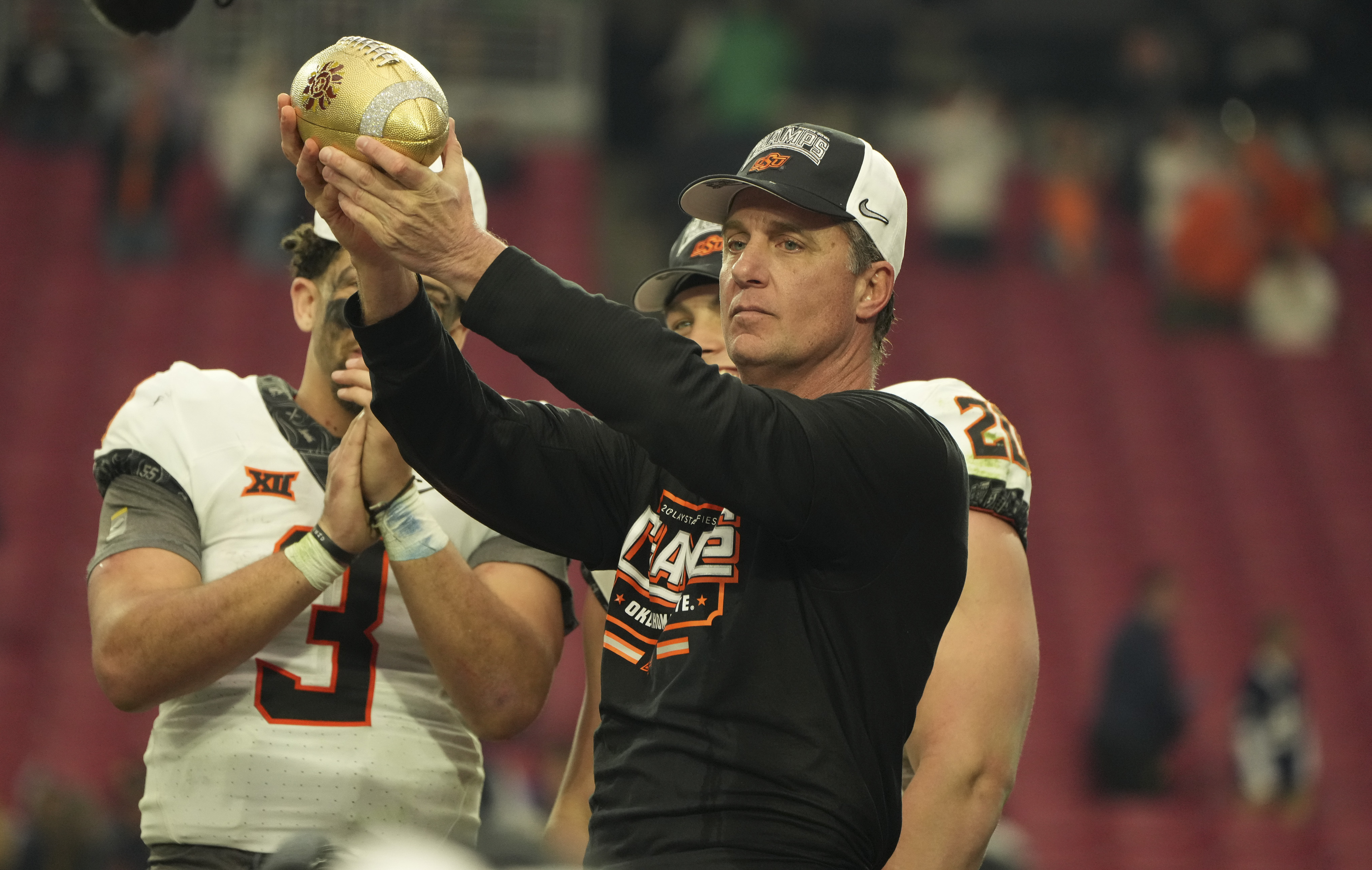 GLENDALE, AZ - JANUARY 01: Oklahoma State Cowboys head coach Mike Gundy accepts the Fiesta Bowl award for winning the Playstation Fiesta Bowl game between the Notre Dame Fighting Irish vs the Oklahoma State Cowboys on January 1st, 2022 at State Farm Stadium in Glendale, AZ. (Photo by Jeff Halstead/Icon Sportswire via Getty Images)