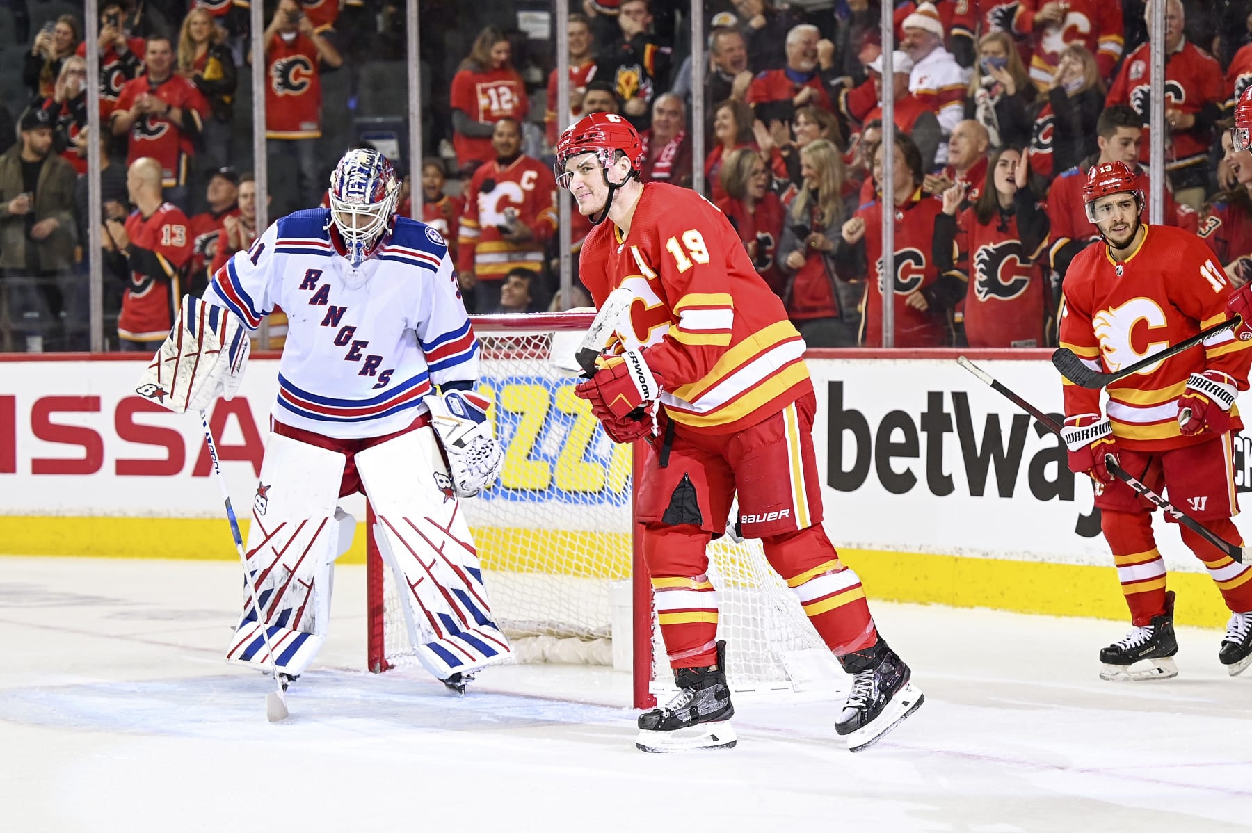 CALGARY, AB - NOVEMBER 06: Calgary Flames Right Wing Matthew Tkachuk (19) celebrates after scoring a goal with his stick between his legs during the third period of an NHL game where the Calgary Flames hosted the New York Rangers on November 6, 2021, at the Scotiabank Saddledome in Calgary, AB. (Photo by Brett Holmes/Icon Sportswire via Getty Images)