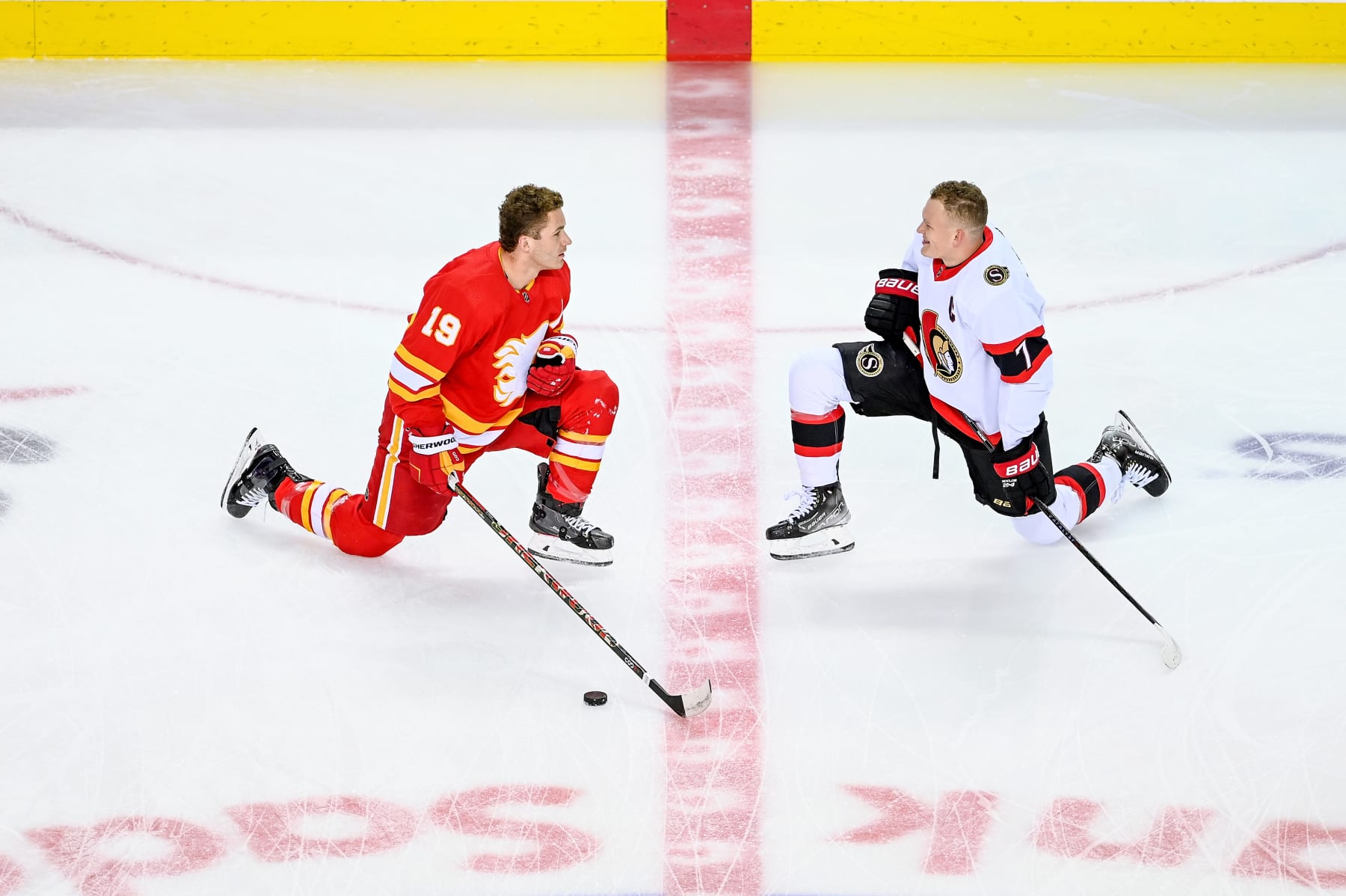CALGARY, AB - JANUARY 13: Brothers Calgary Flames Right Wing Matthew Tkachuk (19) and Ottawa Senators Left Wing Brady Tkachuk (7) warm up before an NHL game where the Calgary Flames hosted the Ottawa Senators on January 13, 2022, at the Scotiabank Saddledome in Calgary, AB. (Photo by Brett Holmes/Icon Sportswire via Getty Images)