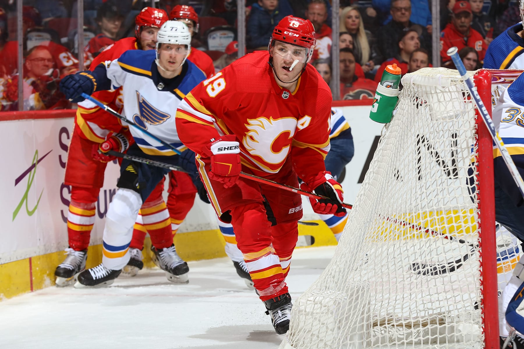 CALGARY, AB - APRIL 2: Matthew Tkachuk #19 of the Calgary Flames battles behind the net against the St Louis Blues at Scotiabank Saddledome on April 2, 2022 in Calgary, Alberta, Canada. (Photo by Gerry Thomas/NHLI via Getty Images)