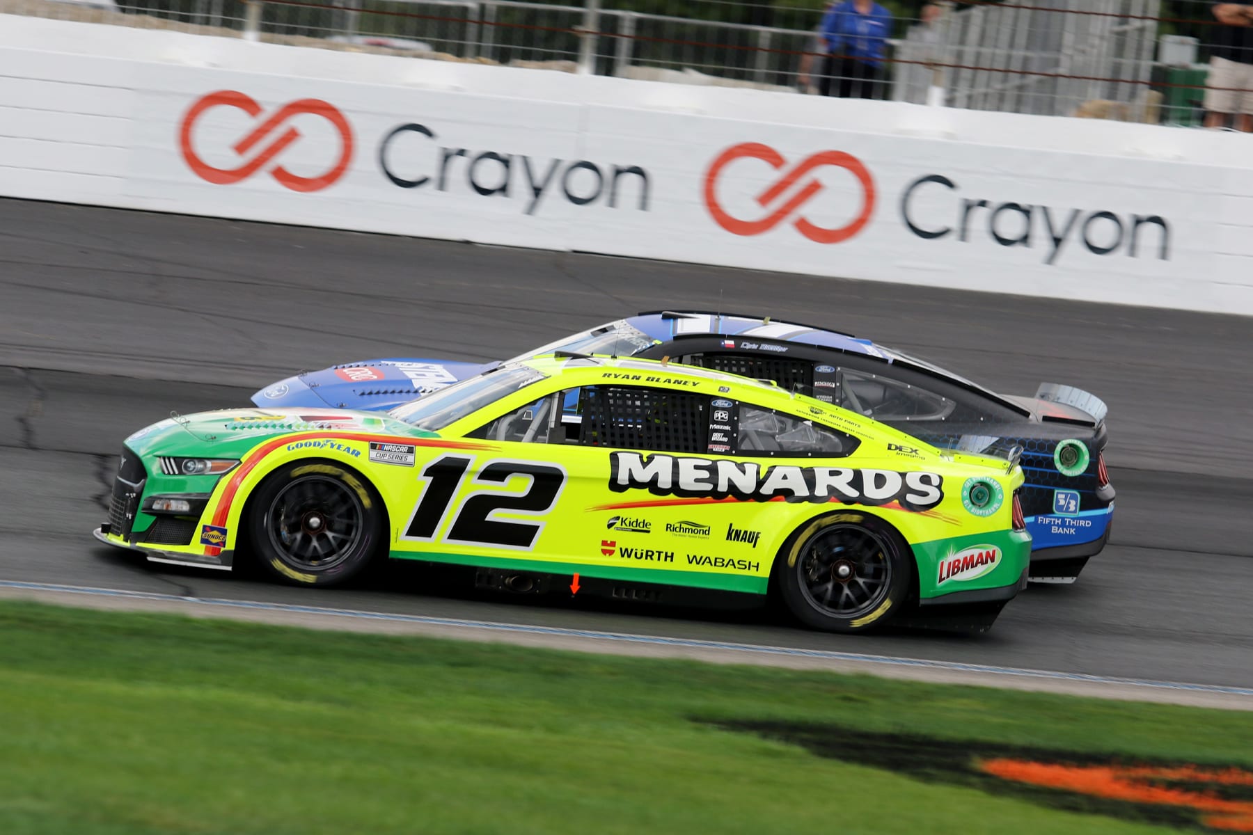 LOUDON, NH - JULY 17: Ryan Blaney (#12 Team Penske Menards/Libman Ford) and Chris Buescher (#17 RFK Racing Fastenal Ford) in turn 4 during the NASCAR Cup Series Ambetter 301 race on July 17, 2022 at the New Hampshire Motor Speedway in Loudon, New Hampshire. (Photo by Malcolm Hope/Icon Sportswire via Getty Images)