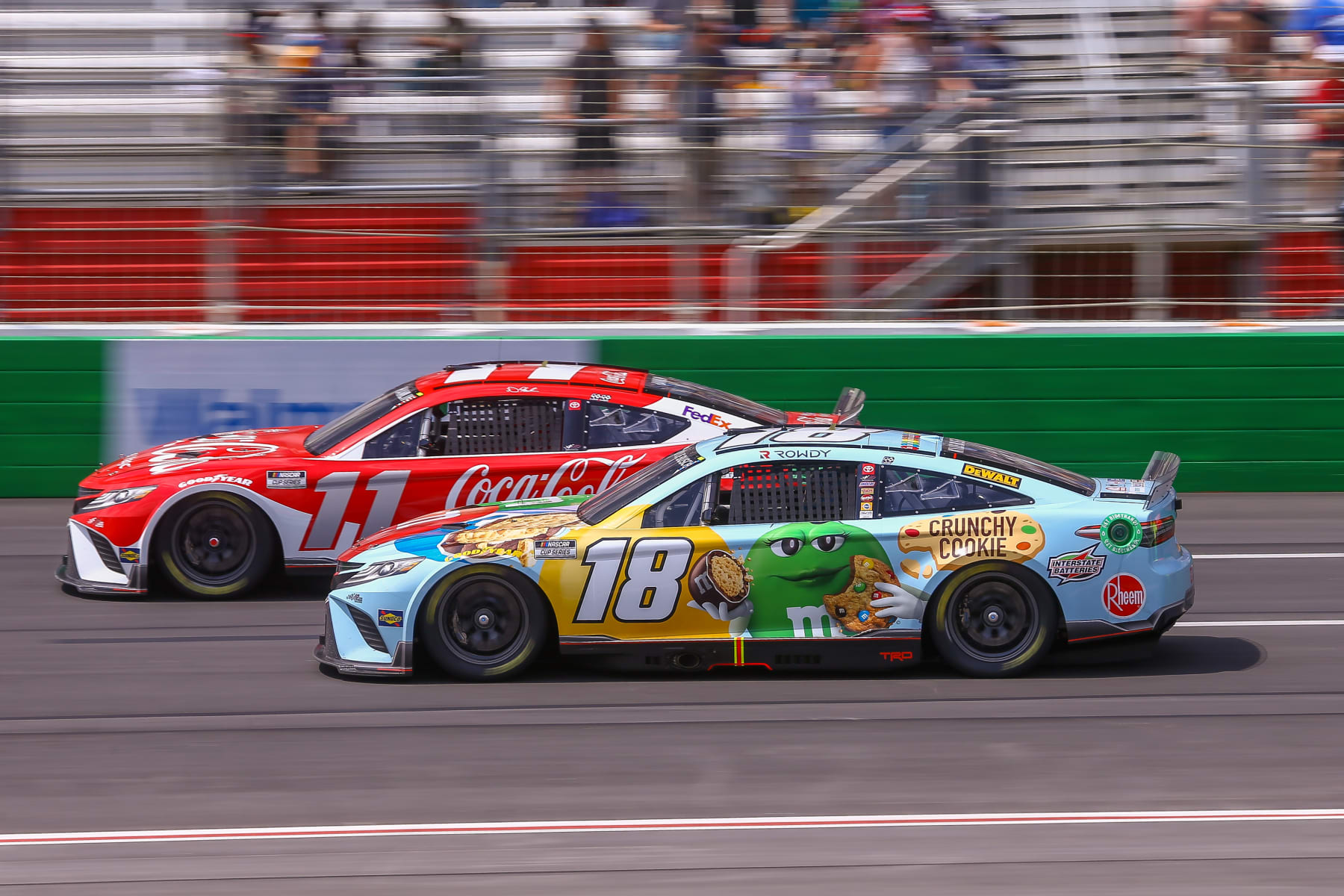 ATLANTA, GA - JULY 10: NASCAR Cup Series driver Denny Hamlin (11) passes NASCAR Cup Series driver Kyle Busch (18) on the outside during the Quaker State 400 Presented by Walmart on July 10, 2022 at Atlanta Motor Speedway in Atlanta, GA. (Photo by Chris McDill/Icon Sportswire via Getty Images)