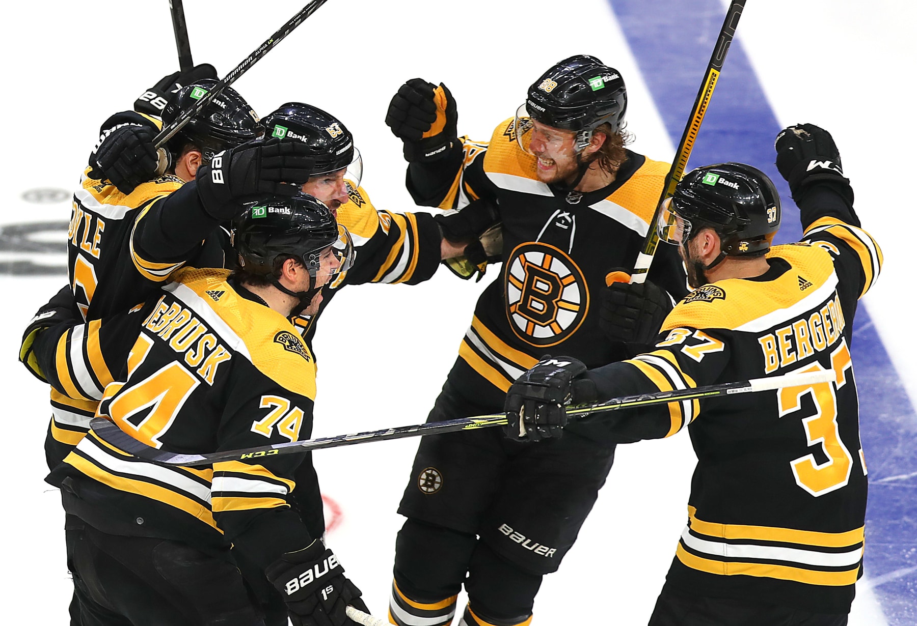 Boston - May 8: The Bruins, Boston Bruins left wing Jake DeBrusk (74), Boston Bruins center Charlie Coyle (13),Boston Bruins left wing Brad Marchand (63), Boston Bruins right wing David Pastrnak (88), and Boston Bruins center Patrice Bergeron (37) celebrate Boston Bruins left wing Brad Marchand (63) (center rear) goal in the 3rd period to put the Bruins ahead, 3-2. The Boston Bruins host the Carolina Hurricanes in an NHL game at TD Garden in Boston on May 8, 2022. (Photo by John Tlumacki/The Boston Globe via Getty Images)