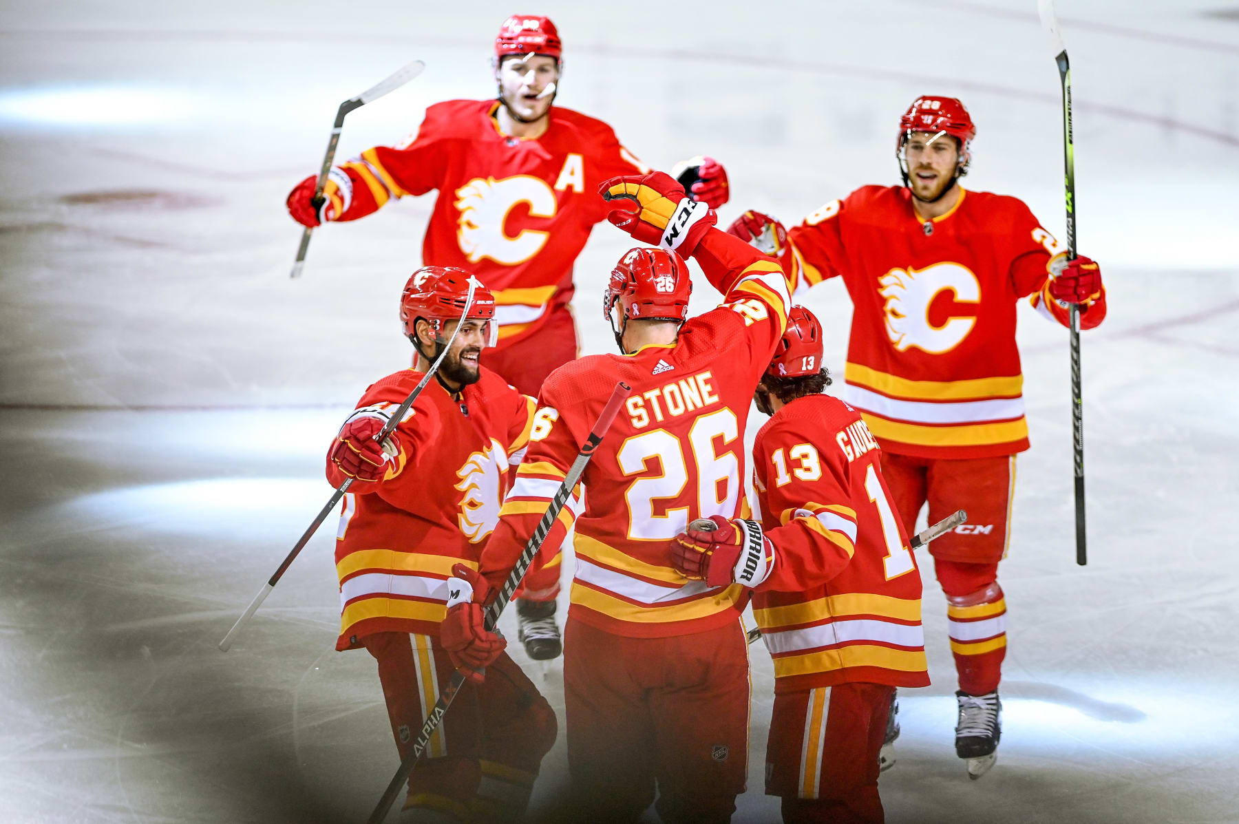 CALGARY, AB - MAY 20: Calgary Flames Defenceman Michael Stone (26) celebrates a goal with Calgary Flames Left Wing Johnny Gaudreau (13), Calgary Flames Defenceman Oliver Kylington (58), Calgary Flames Right Wing Matthew Tkachuk (19) and Calgary Flames Center Elias Lindholm (28) during the first period of game 2 of the second round of the NHL Stanley Cup Playoffs between the Calgary Flames and the Edmonton Oilers on May 20, 2022, at the Scotiabank Saddledome in Calgary, AB. (Photo by Brett Holmes/Icon Sportswire via Getty Images)