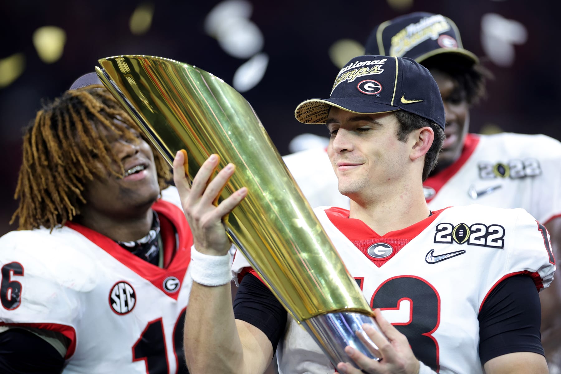 INDIANAPOLIS, INDIANA - JANUARY 10: Stetson Bennett #13 of the Georgia Bulldogs celebrates with the National Championship trophy after the Georgia Bulldogs defeated the Alabama Crimson Tide 33-18 during the 2022 CFP National Championship Game at Lucas Oil Stadium on January 10, 2022 in Indianapolis, Indiana. (Photo by Carmen Mandato/Getty Images)