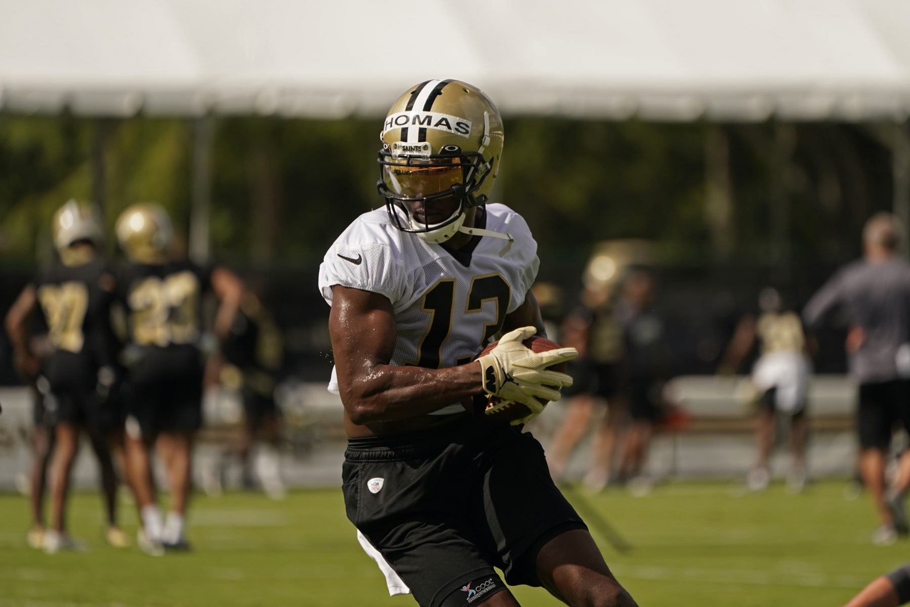 New Orleans Saints wide receiver Michael Thomas (13) runs though drills during training camp at their NFL football training facility in Metairie, La., Wednesday, July 27, 2022. (AP Photo/Gerald Herbert)
