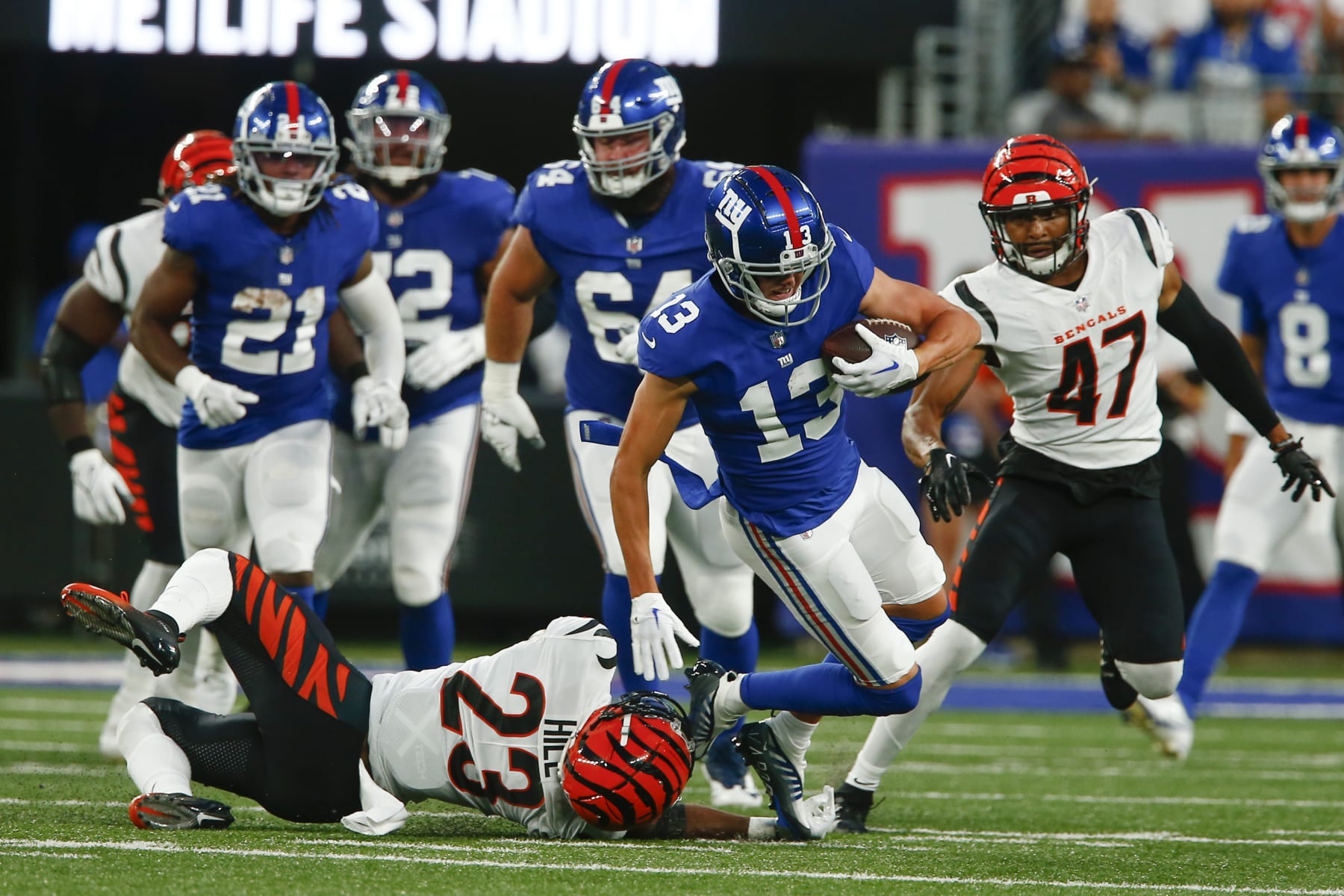Cincinnati Bengals' Dax Hill (23) tackles New York Giants' David Sills (13) during the first half of a preseason NFL football game, Sunday, Aug. 21, 2022, in East Rutherford, N.J. (AP Photo/John Munson) Cincinnati Bengals' Dax Hill (23) tackles New York Giants' David Sills (13) during the first half of a preseason NFL football game, Sunday, Aug. 21, 2022, in East Rutherford, N.J. (AP Photo/John Munson)
