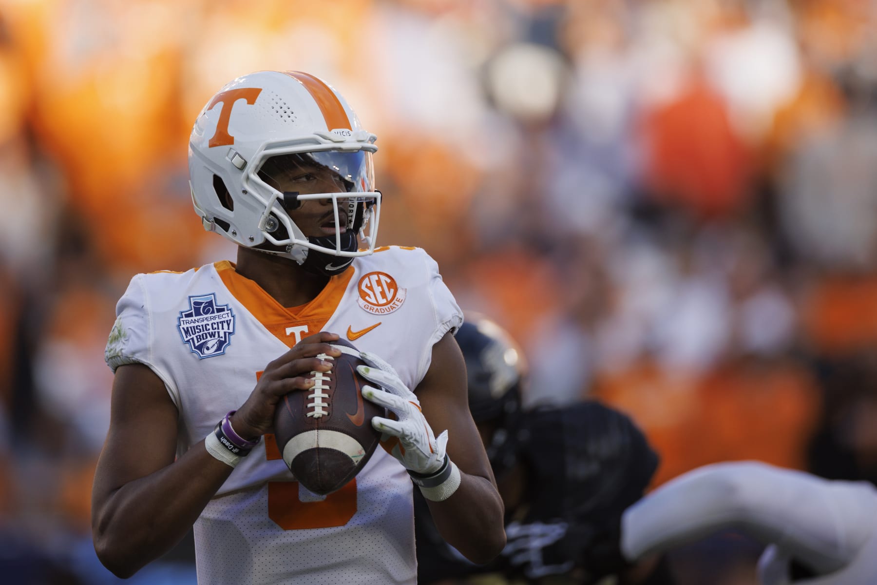 NASHVILLE, TN - DECEMBER 30: Hendon Hooker #5 of the Tennessee Volunteers drops back to pass against the Purdue Boilermakers during the first half of the TransPerfect Music City Bowl at Nissan Stadium on December 30, 2021 in Nashville, Tennessee. (Photo by Brett Carlsen/Getty Images)