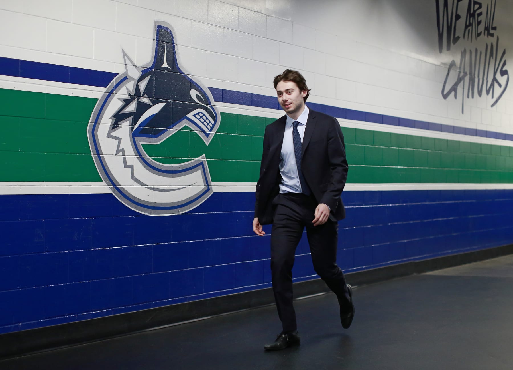 VANCOUVER, BC - APRIL 14: Quinn Hughes #43 of the Vancouver Canucks walks to the Canucks dressing room before their NHL game against the Arizona Coyotes at Rogers Arena April 14, 2022 in Vancouver, British Columbia, Canada. (Photo by Jeff Vinnick/NHLI via Getty Images)