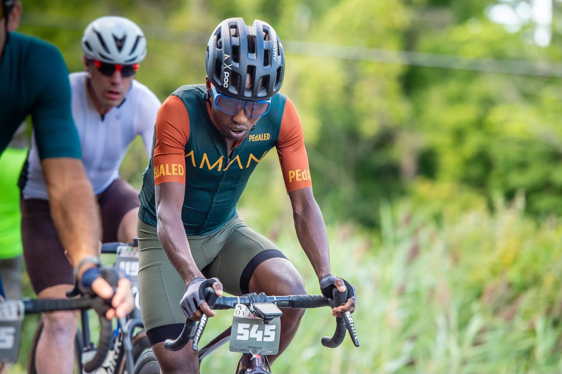 In this photo provided by Joseph Viger, Kenyan cyclist Sule Kangangi cycles at a gravel race in Vermont, Saturday, Aug. 27, 2022. Kangangi died in a crash later in the day, while competing in the race. (Joseph Viger via AP)