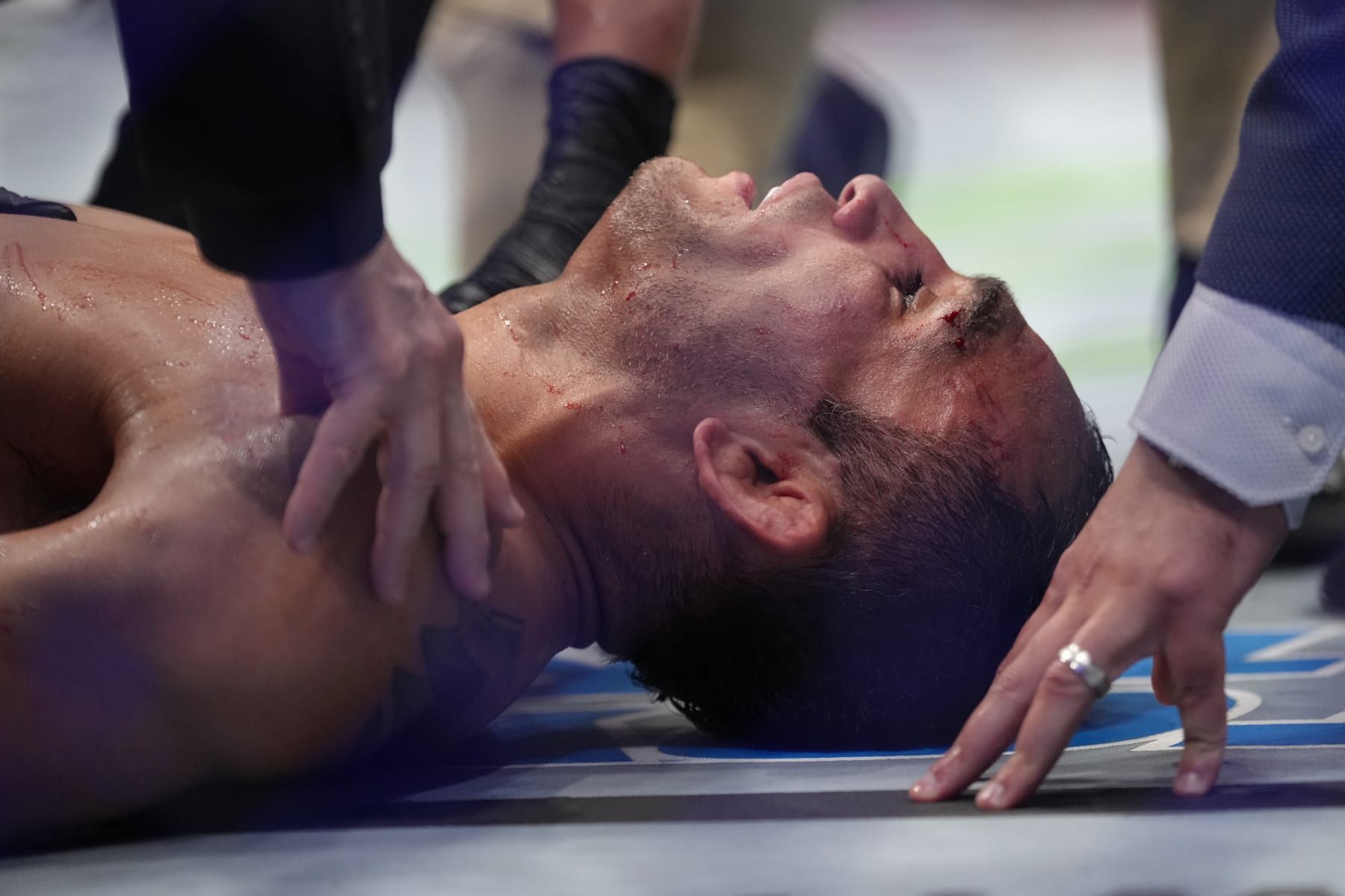 PHOENIX, ARIZONA - MAY 07: Tony Ferguson is treated after his knockout loss to Michael Chandler in a lightweight fight during the UFC 274 event at Footprint Center on May 07, 2022 in Phoenix, Arizona. (Photo by Jeff Bottari/Zuffa LLC)