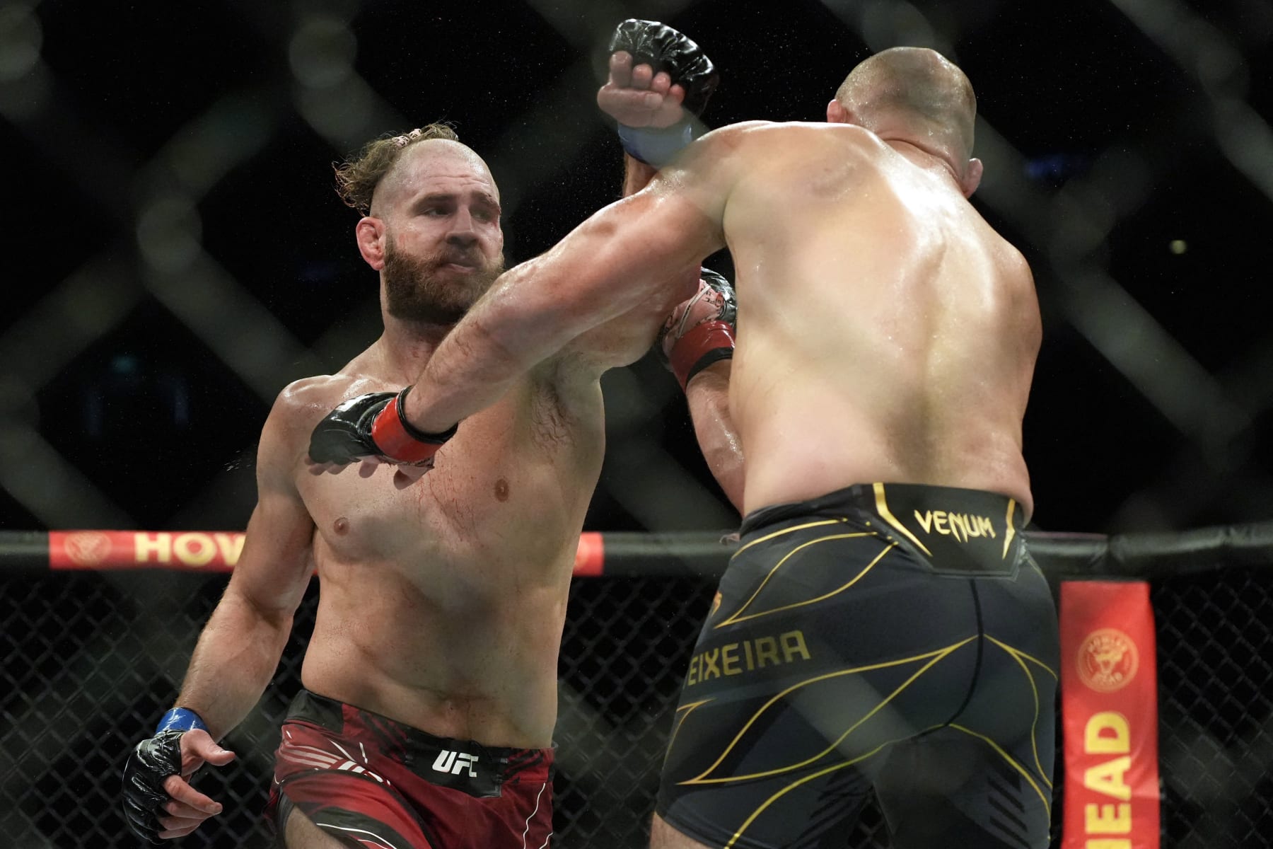 Brazil's Glover Teixeira (R) competes with Czech Republic's Jiri Prochazka in their men's light heavyweight title match during the Ultimate Fighting Championship (UFC) 275 event in Singapore on June 12, 2022. (Photo by NICHOLAS YEO / AFP) (Photo by NICHOLAS YEO/AFP via Getty Images)