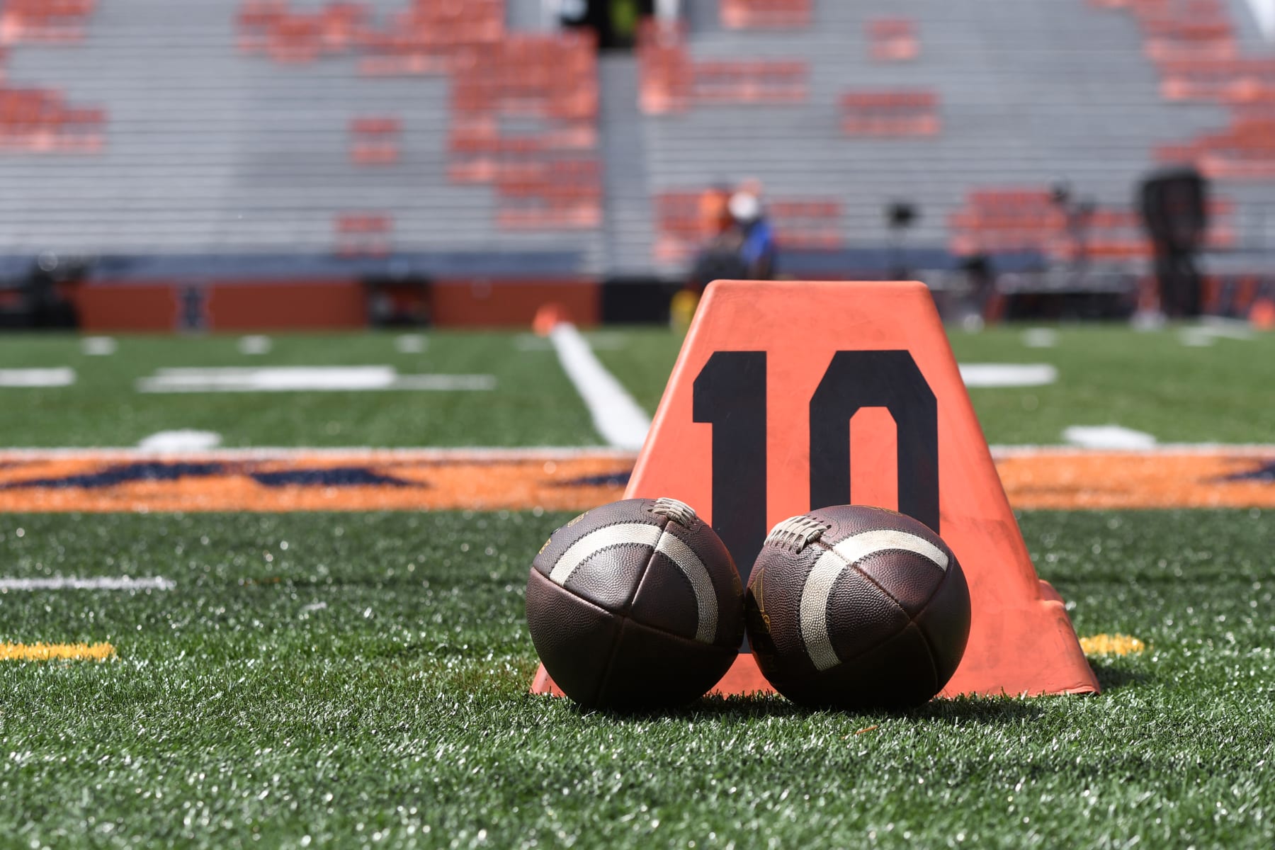 CHAMPAIGN, IL - AUGUST 27: An overview of footballs as they sit on the field beside the 10 yard line marker before the college football game between the Wyoming Cowboys and the Illinois Fighting Illini on August 27, 2022, at Memorial Stadium in Champaign, Illinois. (Photo by Michael Allio/Icon Sportswire via Getty Images)