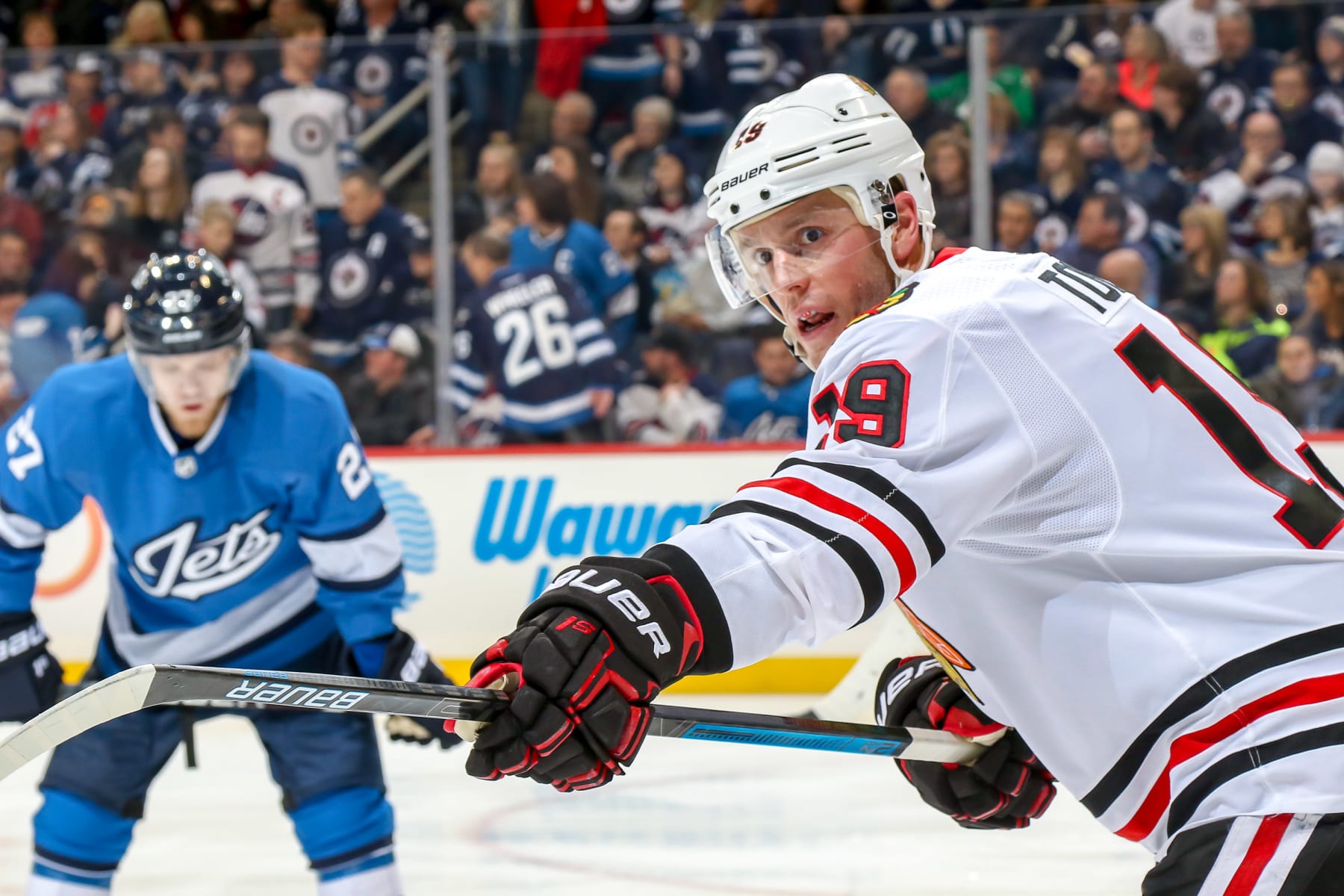WINNIPEG, MB - DECEMBER 11: Jonathan Toews #19 of the Chicago Blackhawks directs his teammates before a third period face-off against the Winnipeg Jets at the Bell MTS Place on December 11, 2018 in Winnipeg, Manitoba, Canada. (Photo by Jonathan Kozub/NHLI via Getty Images)