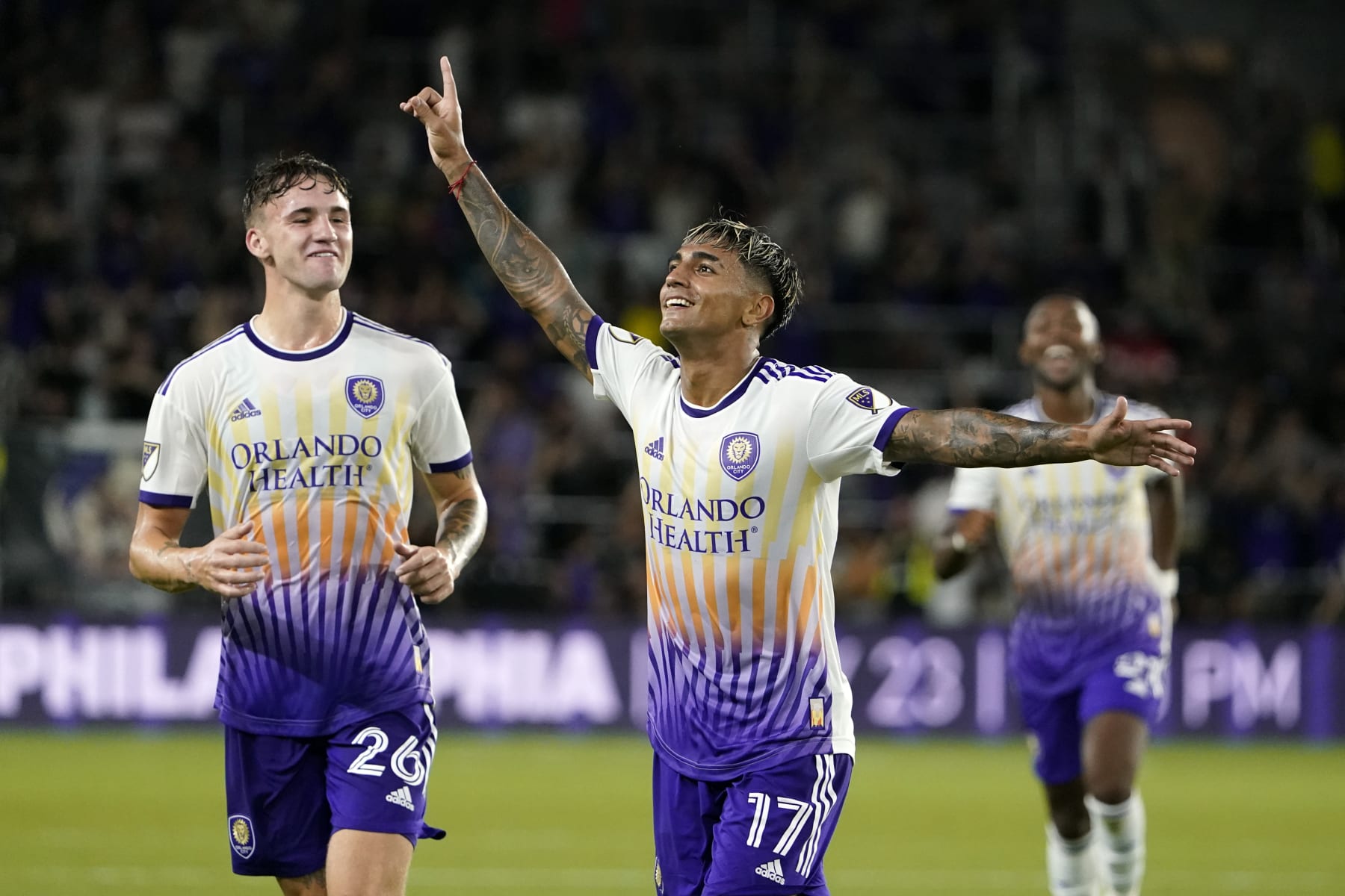 Orlando City's Facundo Torres (17) celebrates with Michael Halliday (26) after scoring a goal against Arsenal during the first half of a Florida Cup friendly soccer match Wednesday, July 20, 2022, in Orlando, Fla. (AP Photo/John Raoux)