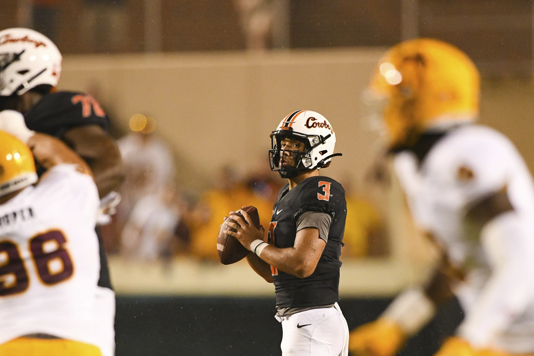 Oklahoma State quarterback Spencer Sanders (3) looks for an open teammate during the second half of an NCAA college football game against Arizona State, Saturday, Sept. 10, 2022, in Stillwater, Okla. (AP Photo/Brody Schmidt) Oklahoma State quarterback Spencer Sanders (3) looks for an open teammate during the second half of an NCAA college football game against Arizona State, Saturday, Sept. 10, 2022, in Stillwater, Okla. (AP Photo/Brody Schmidt)