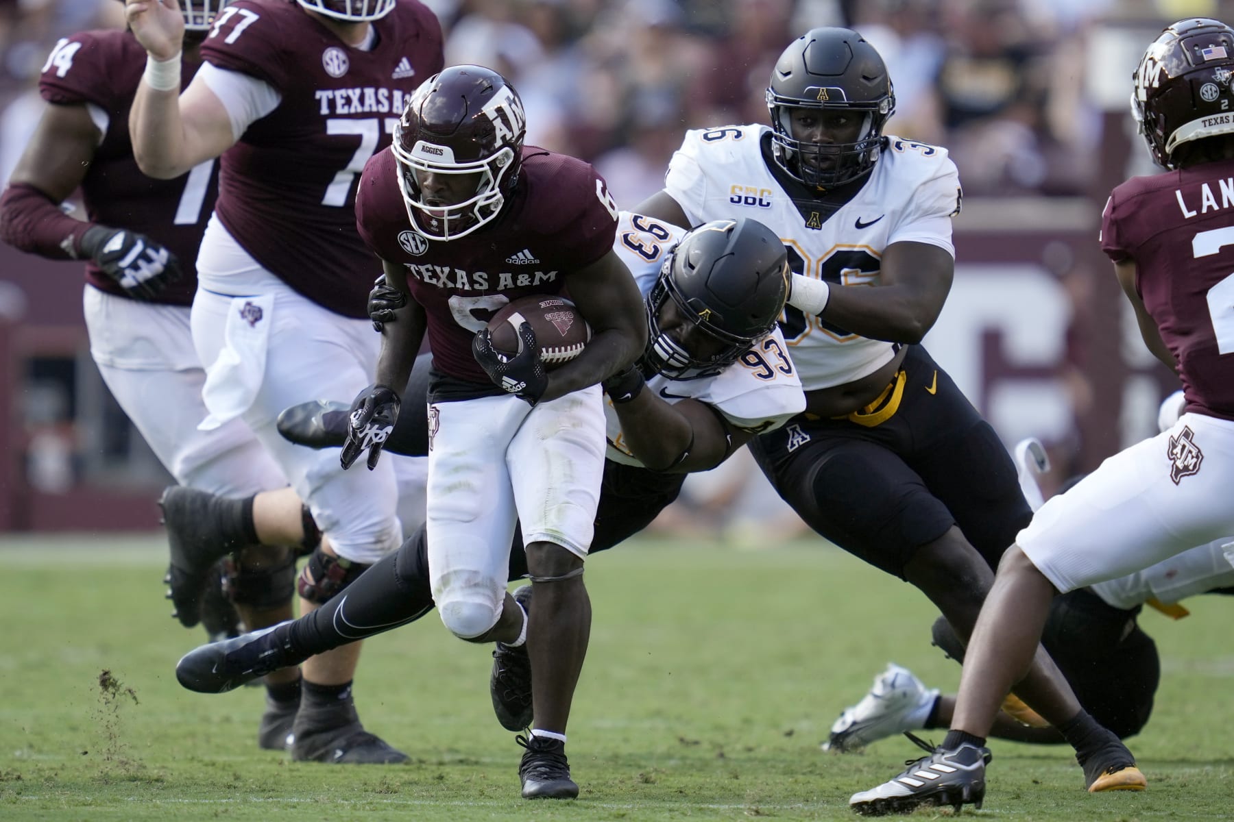 Appalachian State defensive lineman KaRon White (93) brings down Texas A&M running back Devon Achane (6) after a short gain during the second half of an NCAA college football game Saturday, Sept. 10, 2022, in College Station, Texas. (AP Photo/Sam Craft) Appalachian State defensive lineman KaRon White (93) brings down Texas A&M running back Devon Achane (6) after a short gain during the second half of an NCAA college football game Saturday, Sept. 10, 2022, in College Station, Texas. (AP Photo/Sam Craft)