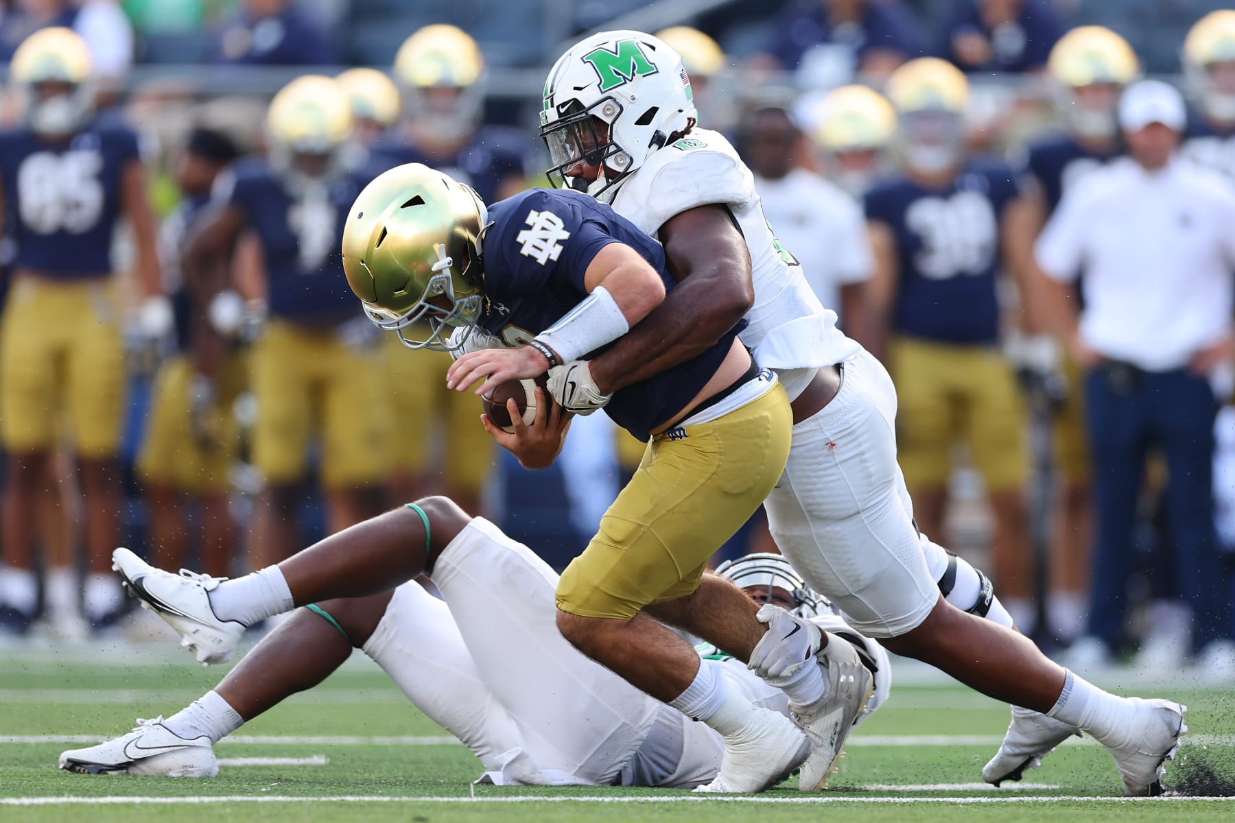 SOUTH BEND, INDIANA - SEPTEMBER 10: Sam Burton #0 of the Marshall Thundering Herd sacks Drew Pyne #10 of the Notre Dame Fighting Irish during the second half at Notre Dame Stadium on September 10, 2022 in South Bend, Indiana. (Photo by Michael Reaves/Getty Images)