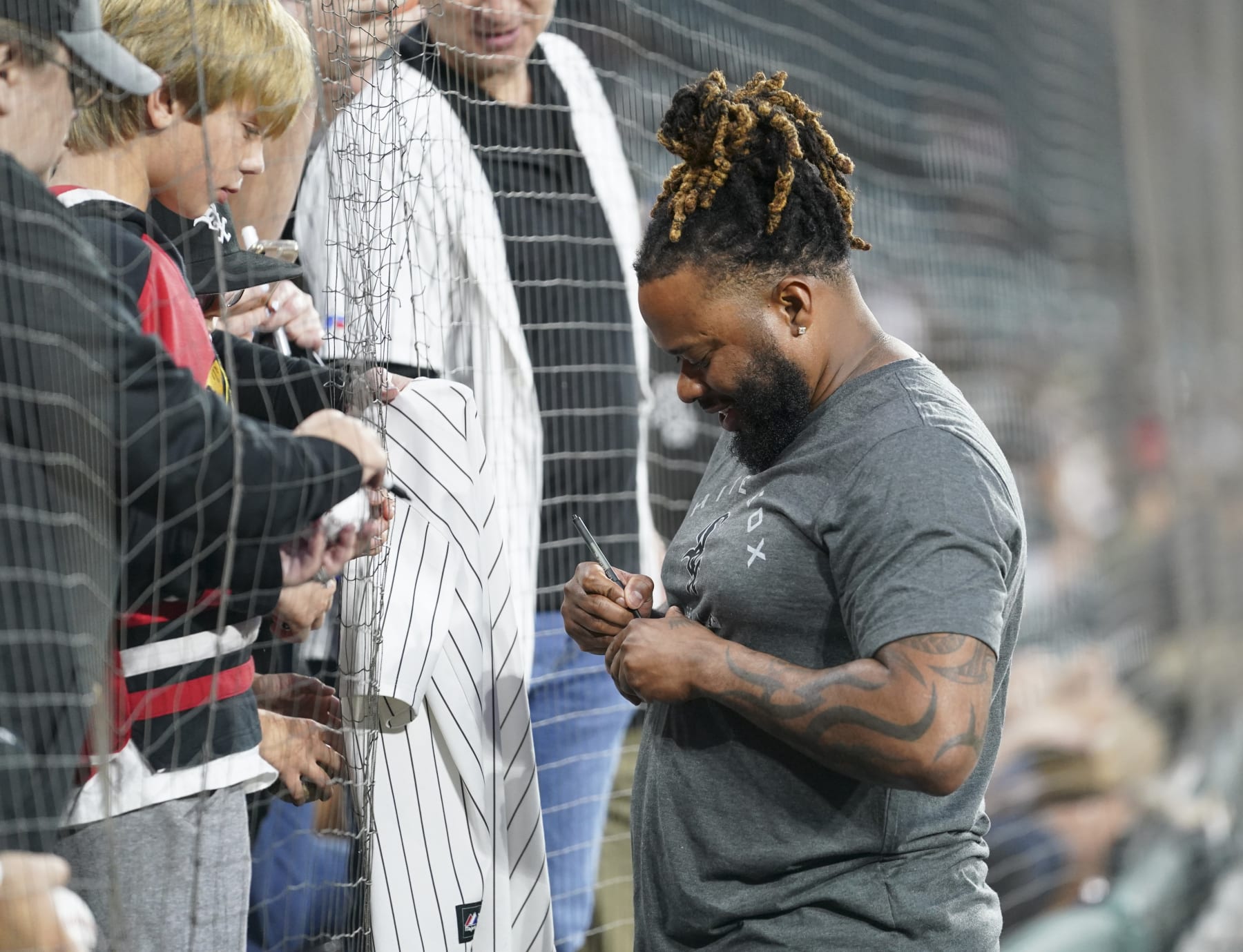 CHICAGO, ILLINOIS - SEPTEMBER 13:  Johnny Cueto #47 of the Chicago White Sox signs autographs for fans prior to a game against the Colorado Rockies at Guaranteed Rate Field on September 13, 2022 in Chicago, Illinois. (Photo by Nuccio DiNuzzo/Getty Images)
